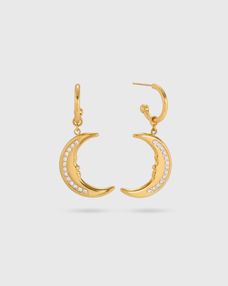 Gold crescent moon earrings on a light gray background