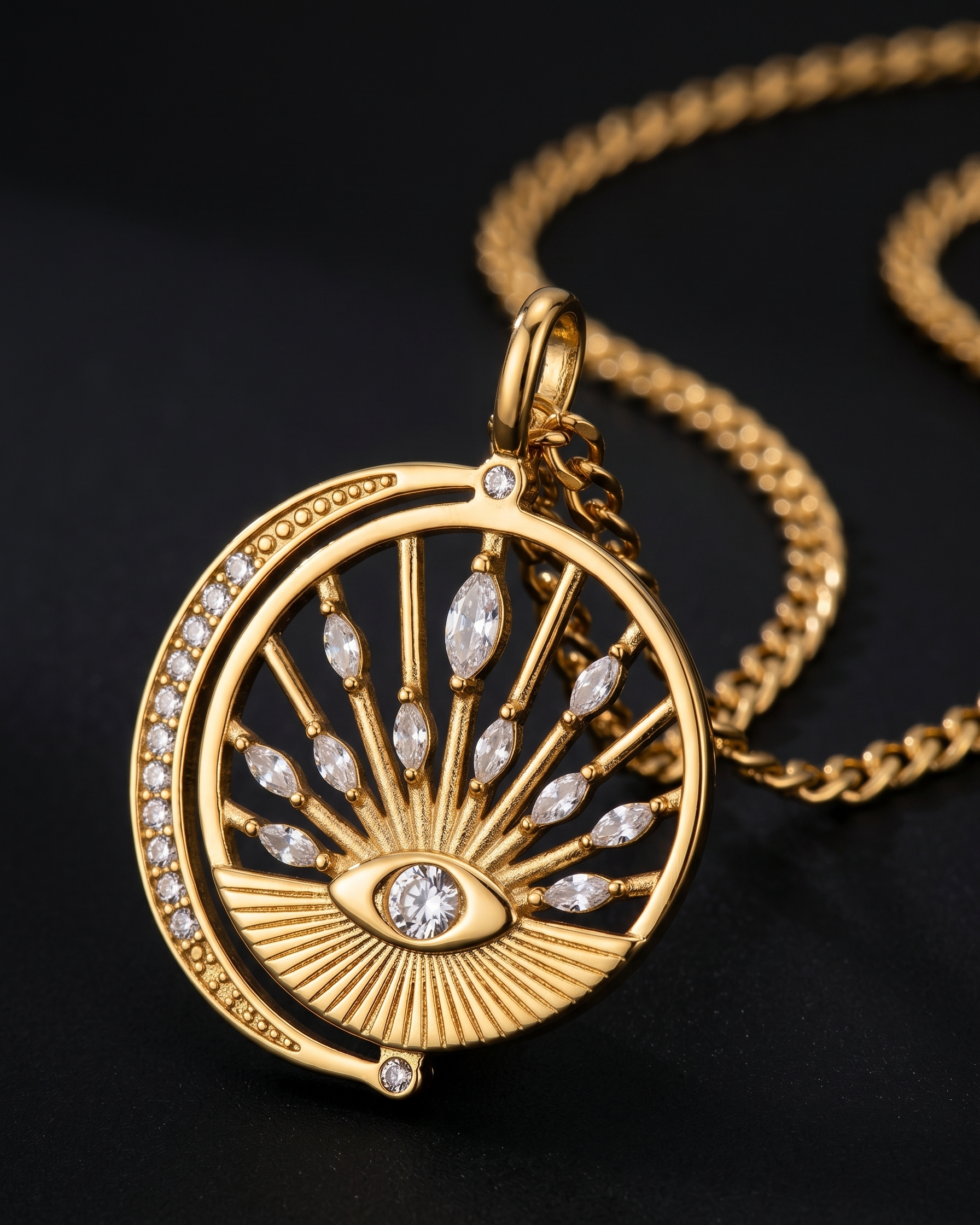 Gold necklace with a circular pendant featuring an eye design on a black background
