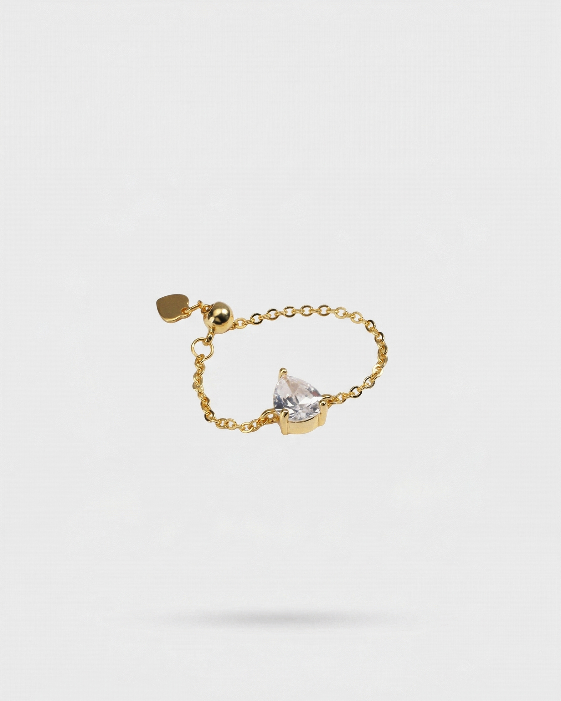 Gold ring with a diamond on a light gray background