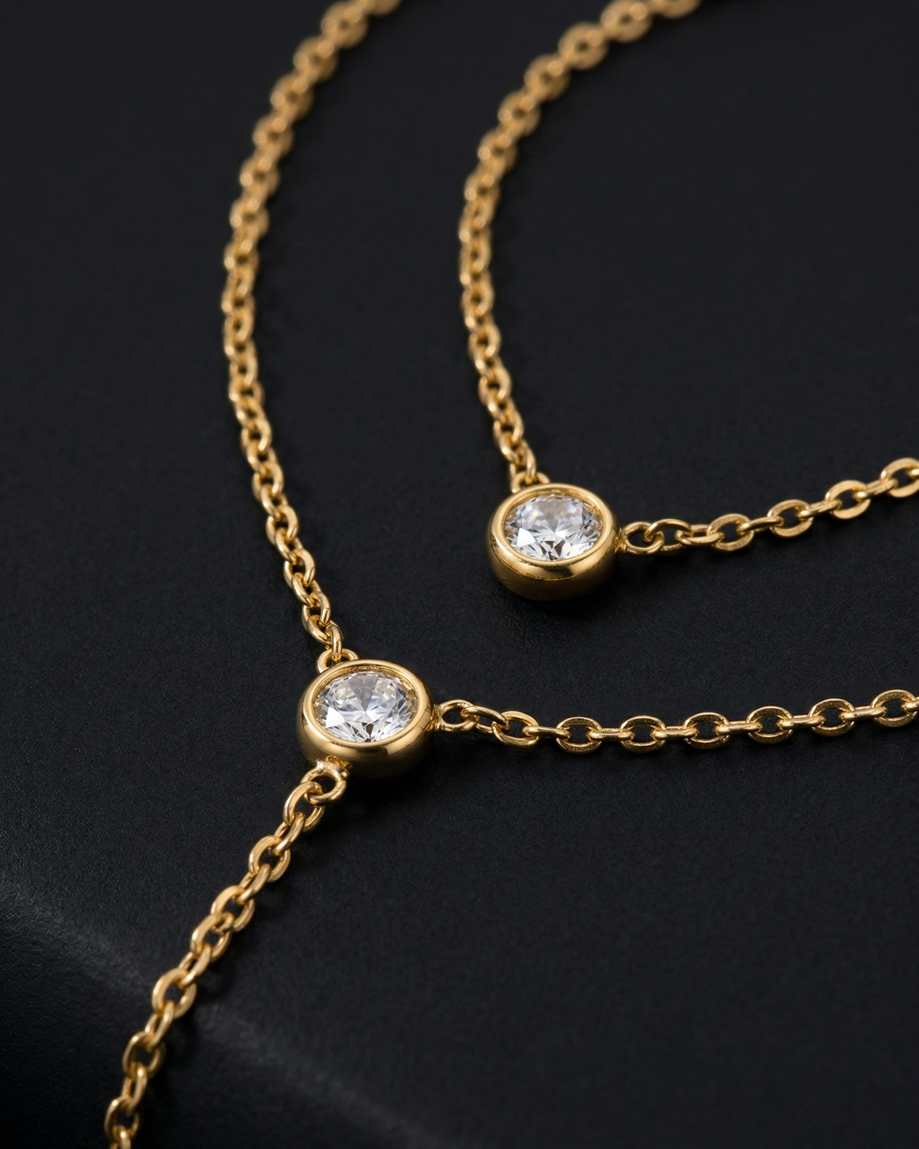 Gold necklace with diamond pendants on a black background