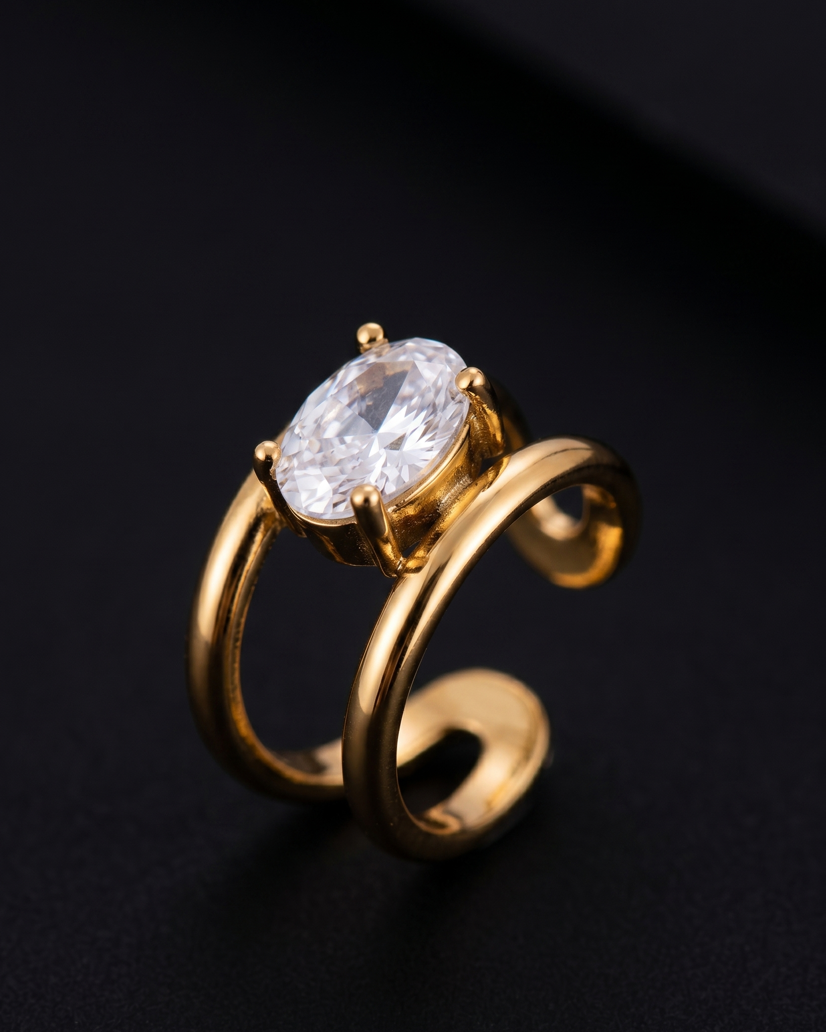 Gold ring with a large diamond on a black background