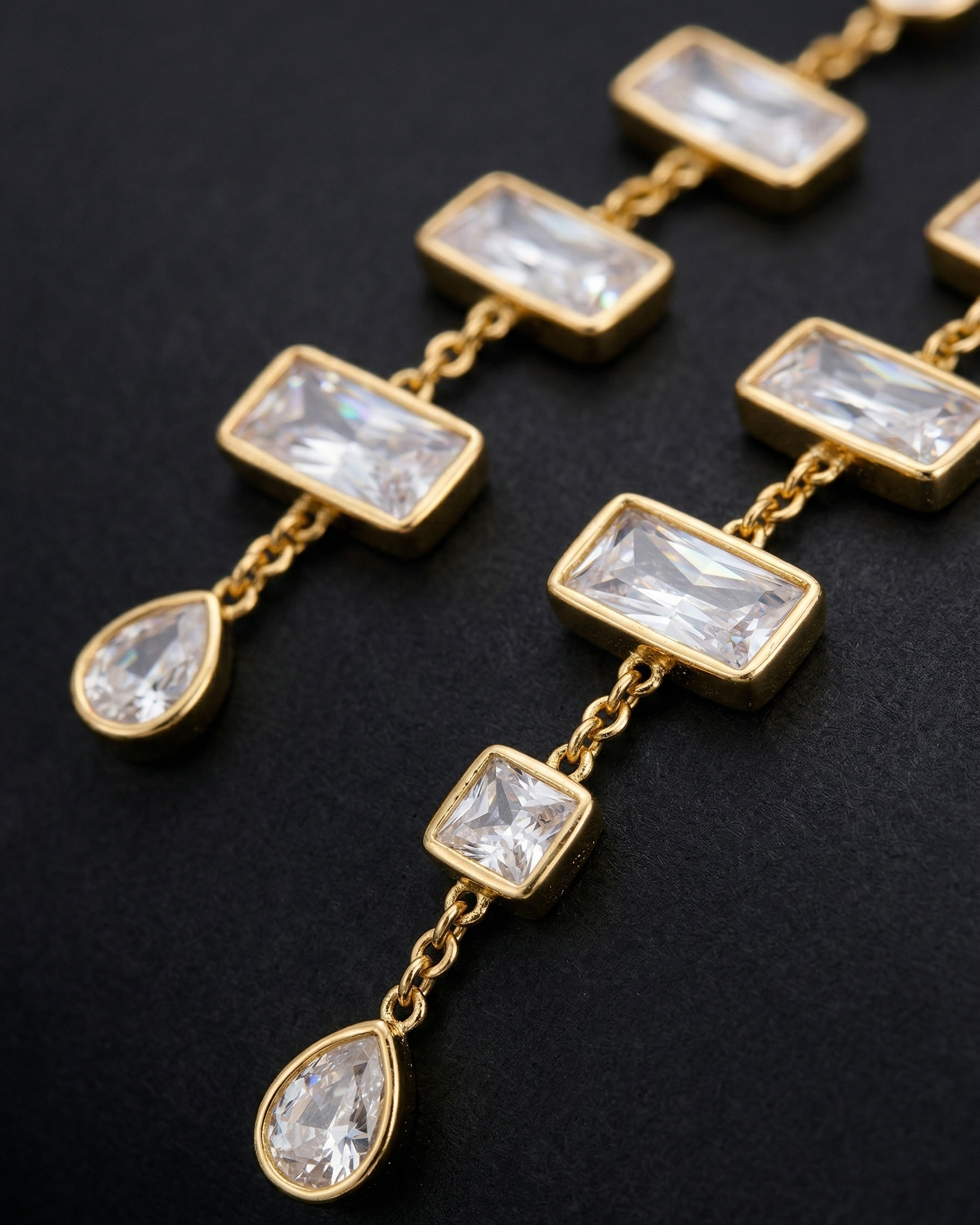 Gold necklace with clear gemstones on a dark background