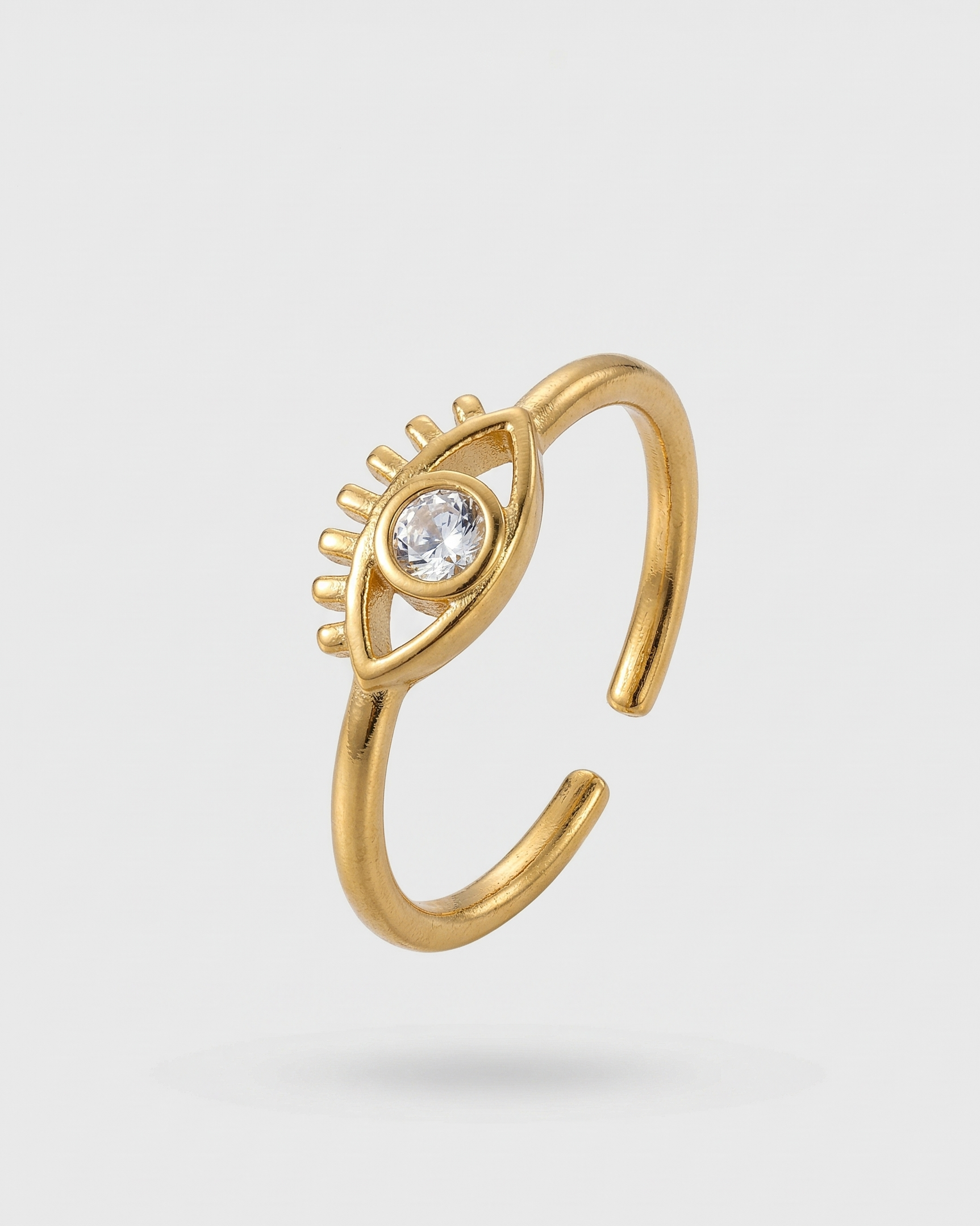 Gold ring with a diamond on a light gray background