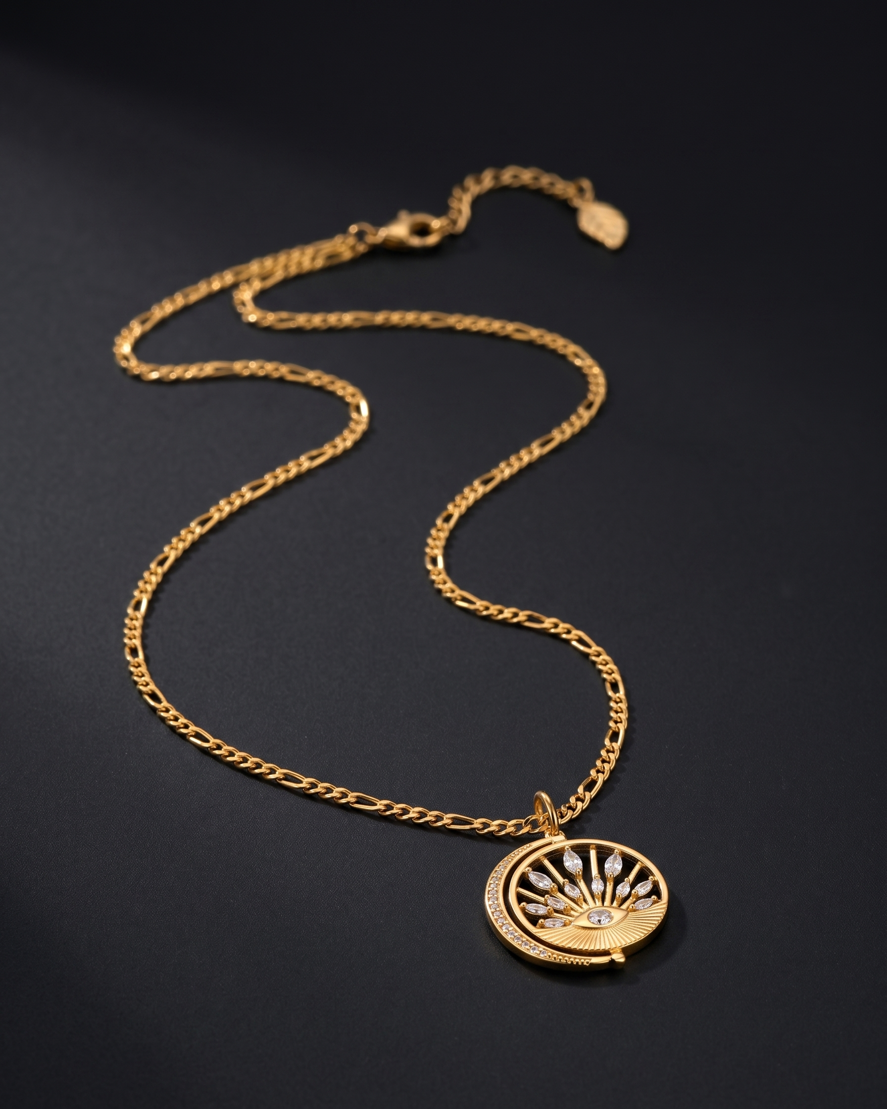 Gold necklace with a decorative pendant on a black background