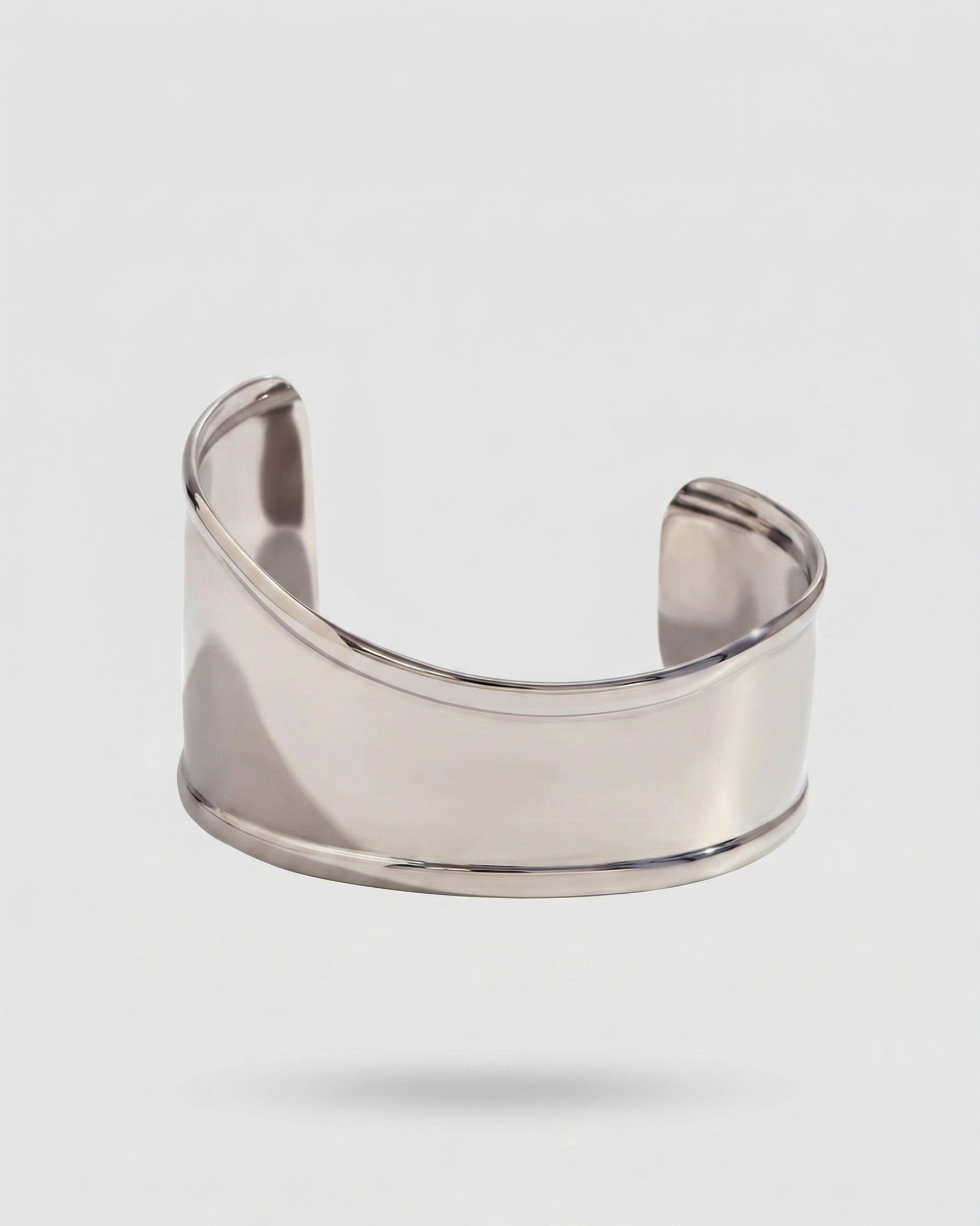 Silver cuff bracelet on a light gray background