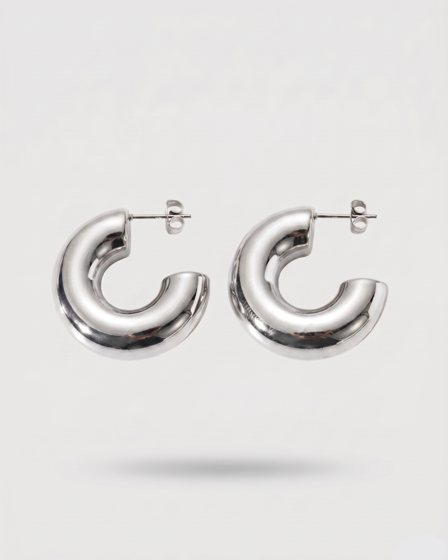 Silver hoop earrings on a white background