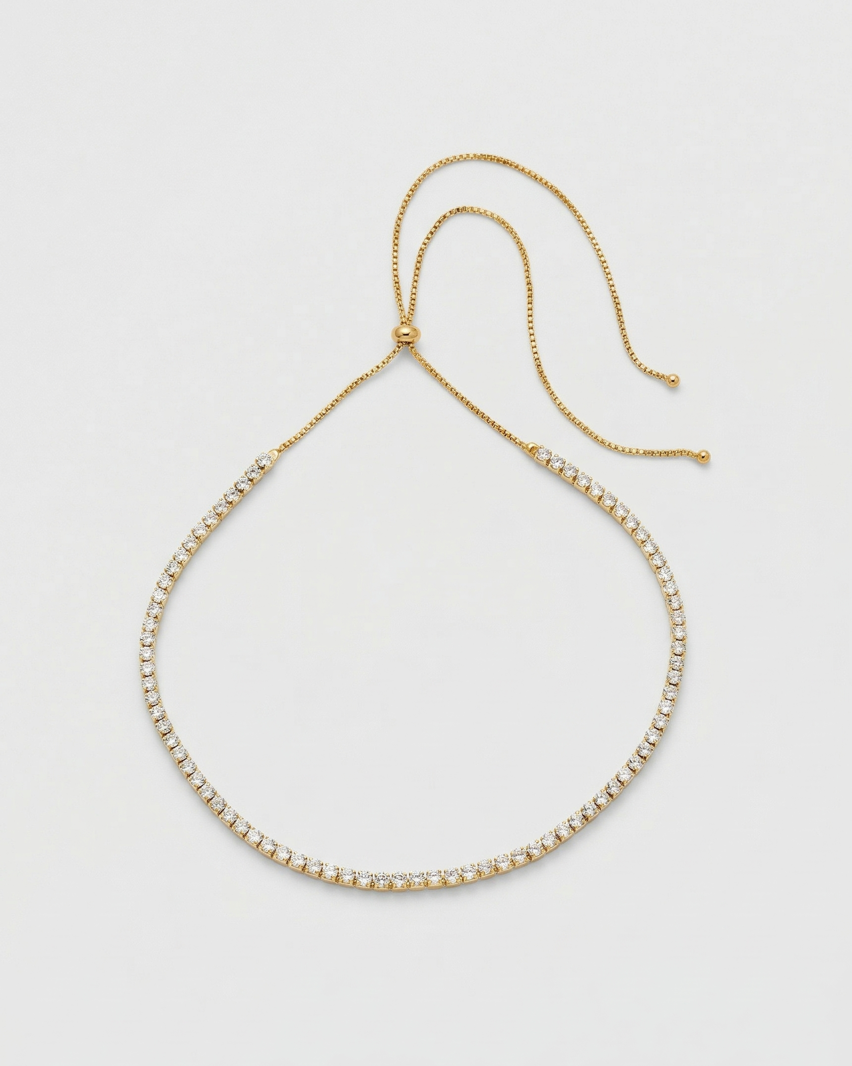 Gold beaded bracelet on a light gray background