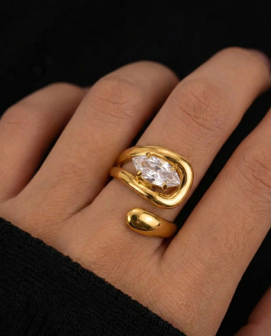 Gold ring with a large diamond on a hand against a black background
