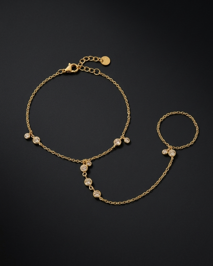 Gold anklet with pearl-like beads on a black background