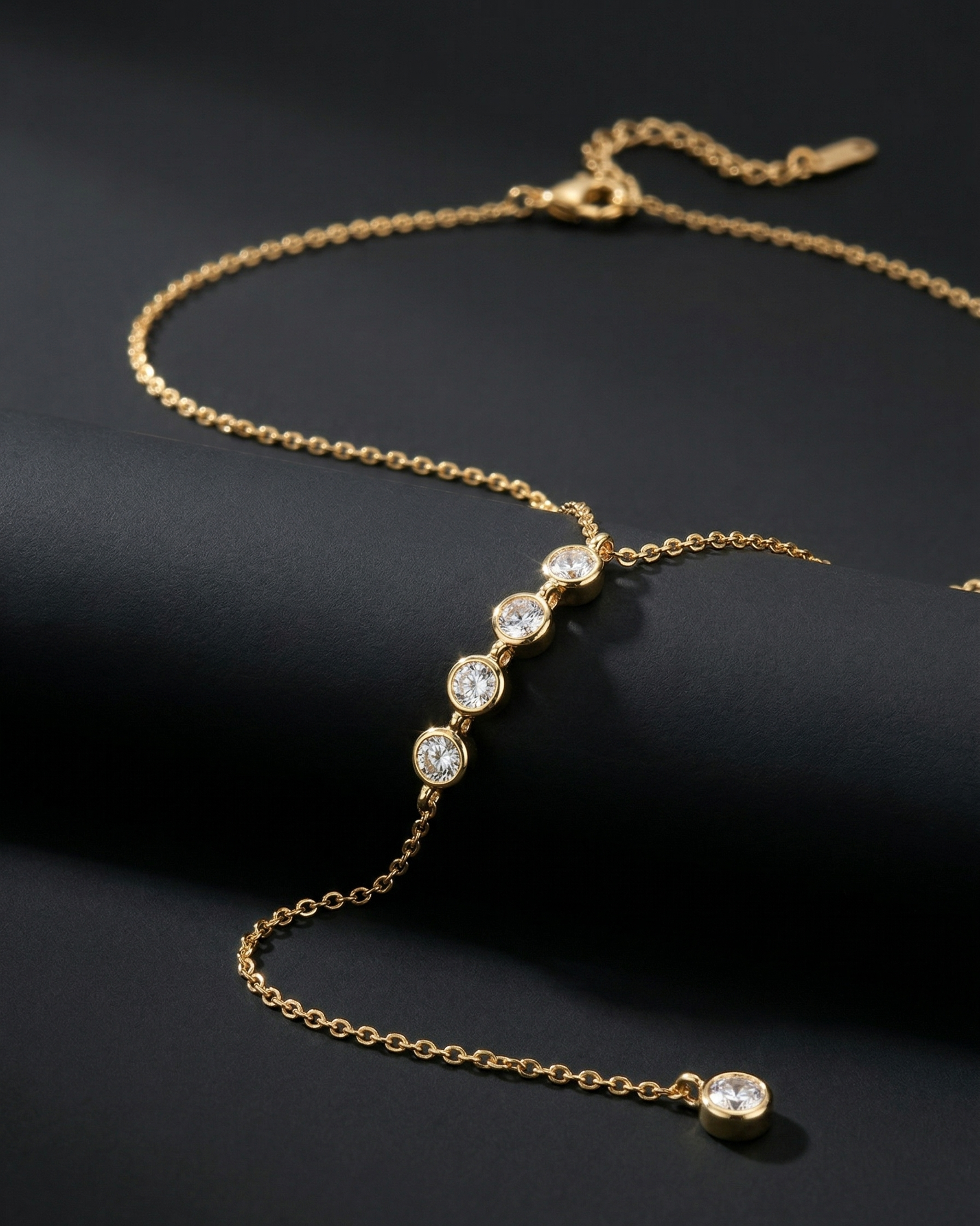 Gold necklace with diamond beads on a black background