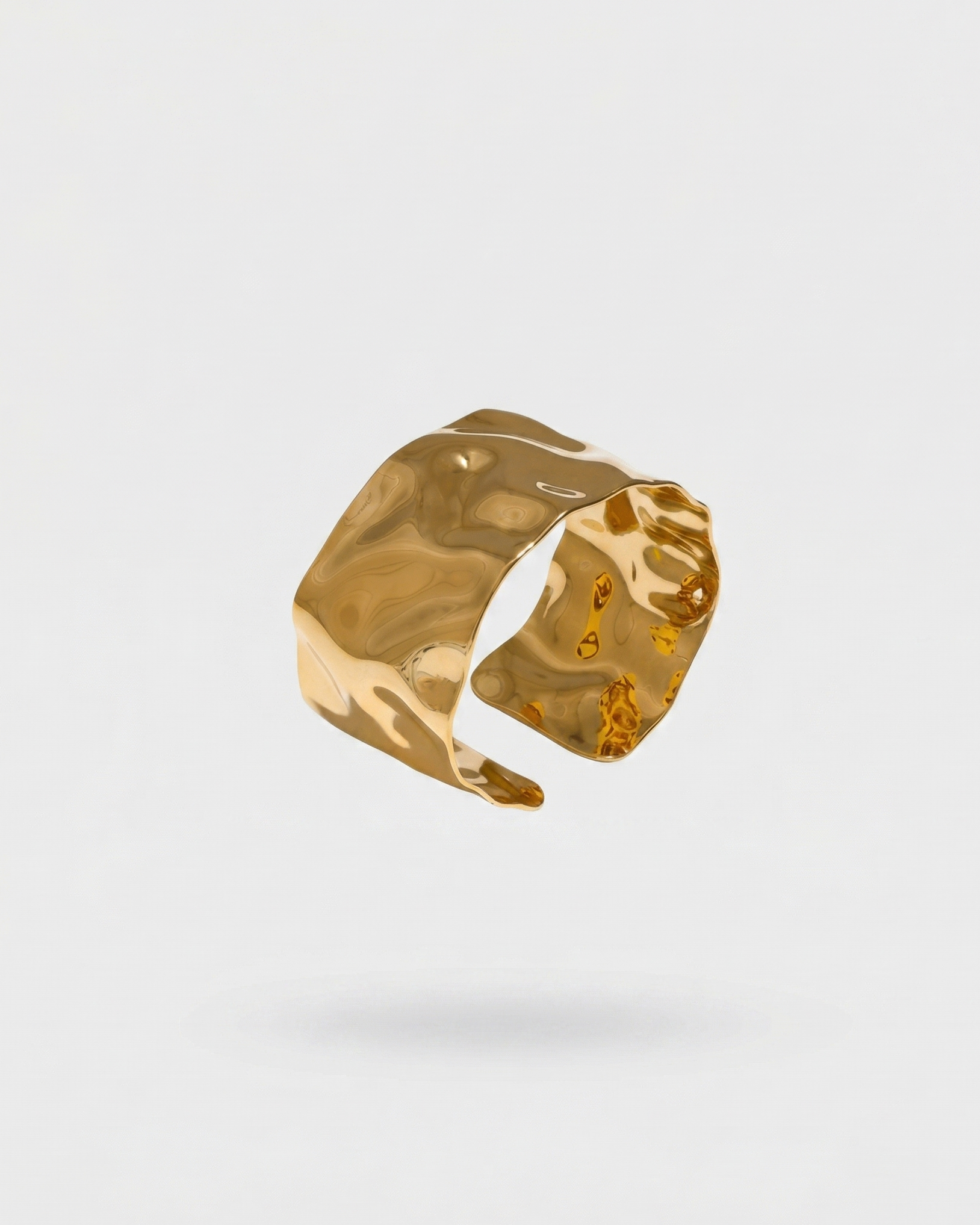 Gold ring on a light gray background