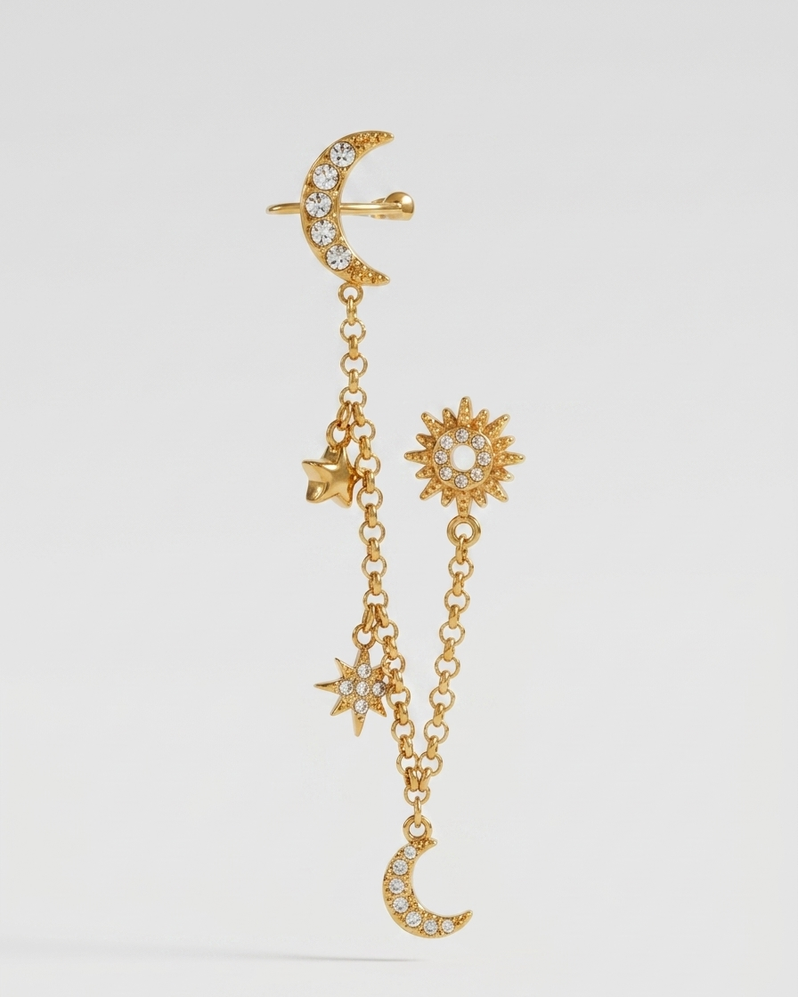 Gold earring with celestial charms on a white background