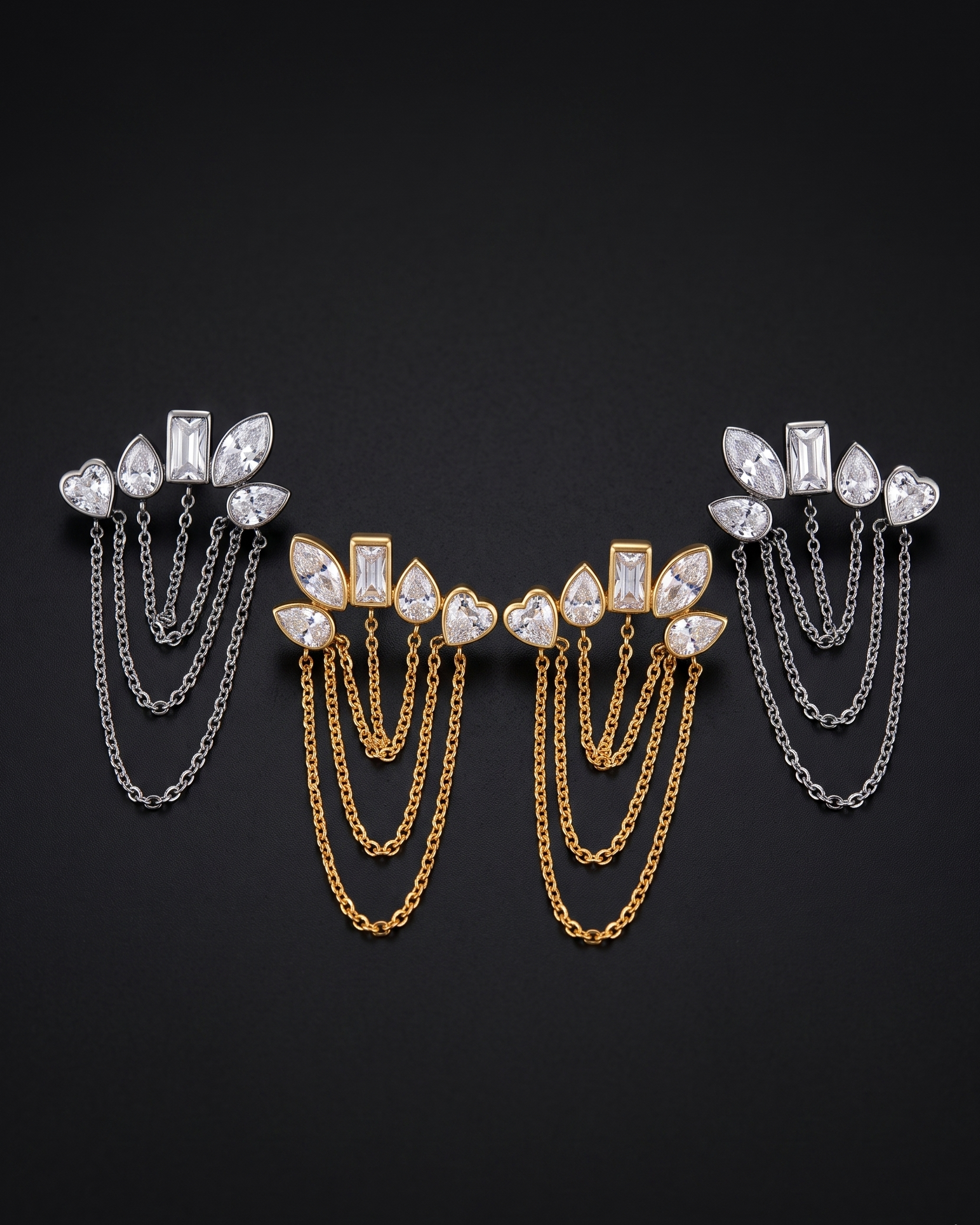 Pair of earrings with gemstones and chains on a black background