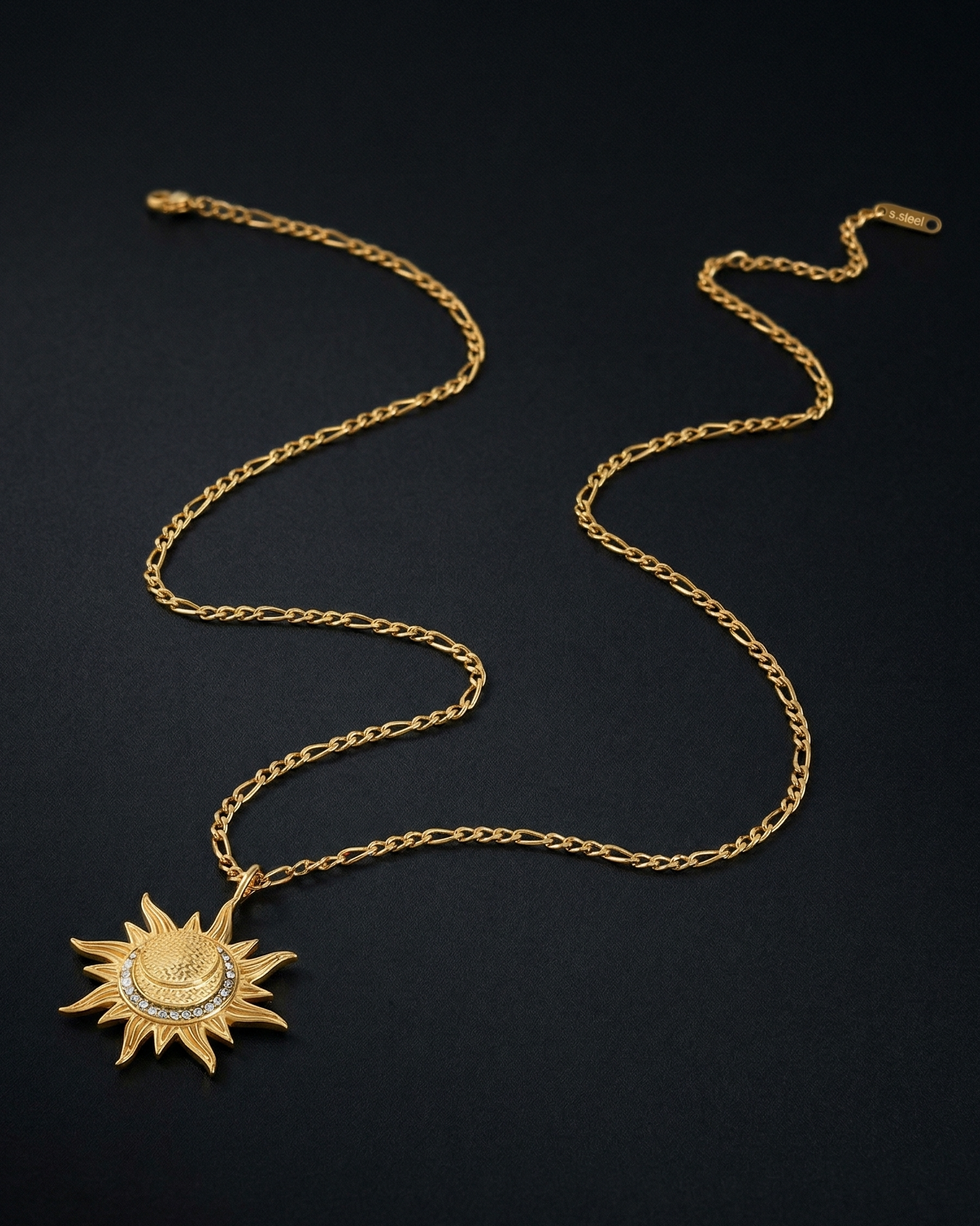 Gold necklace with a sun pendant on a black background