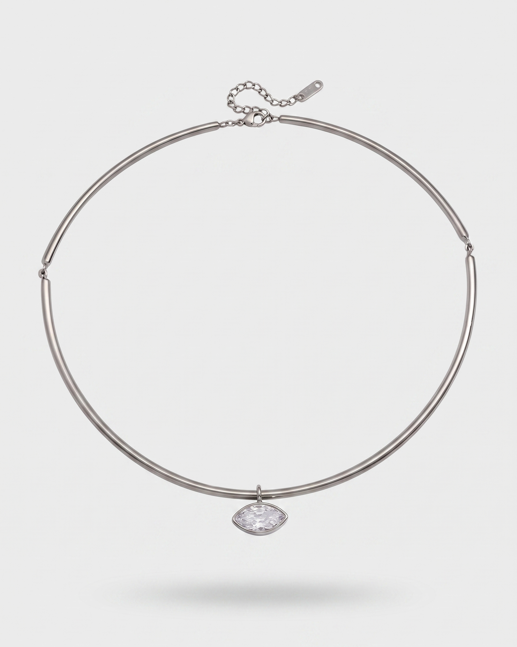 Silver necklace with a pendant on a light gray background