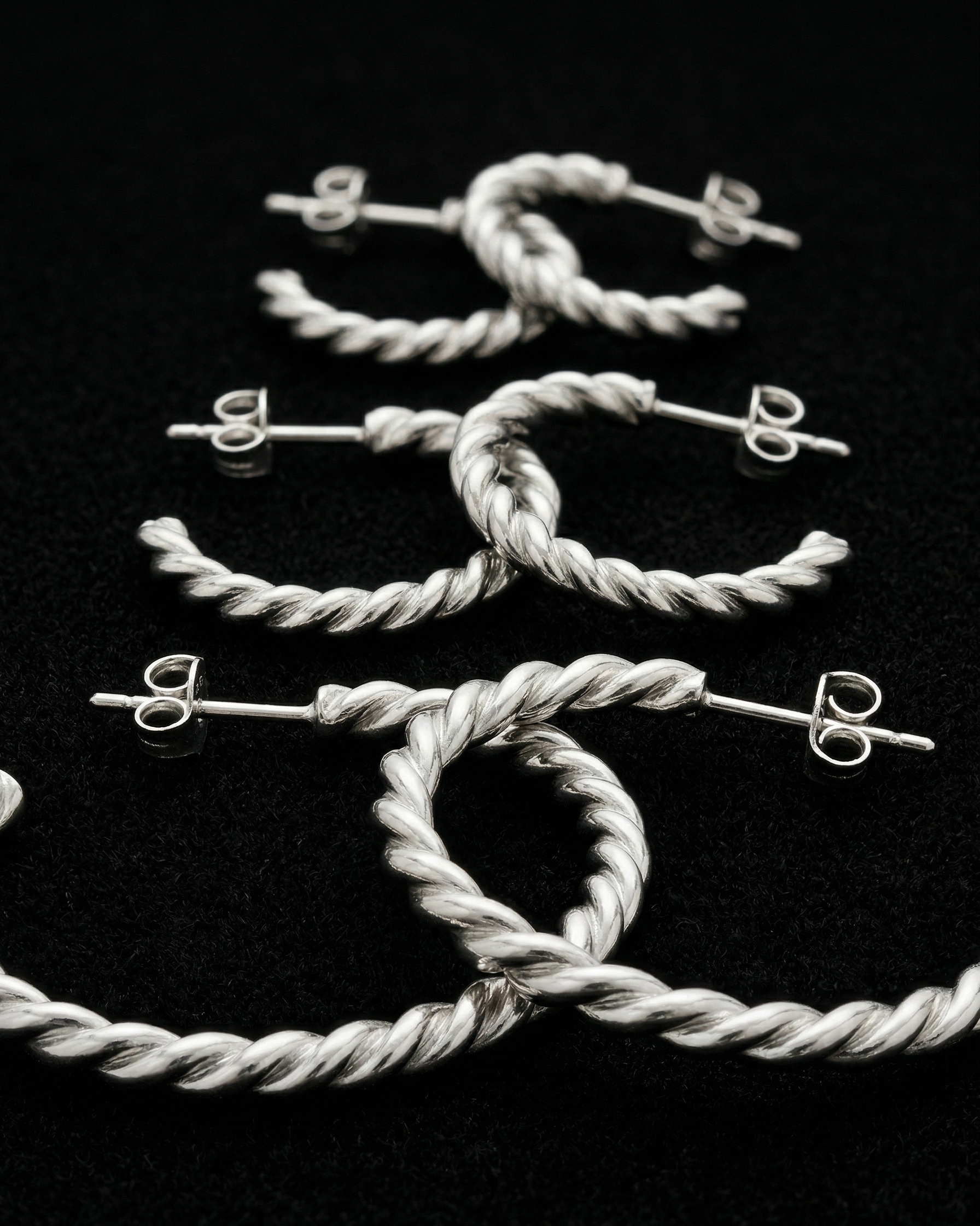 Silver jewelry set on a black background
