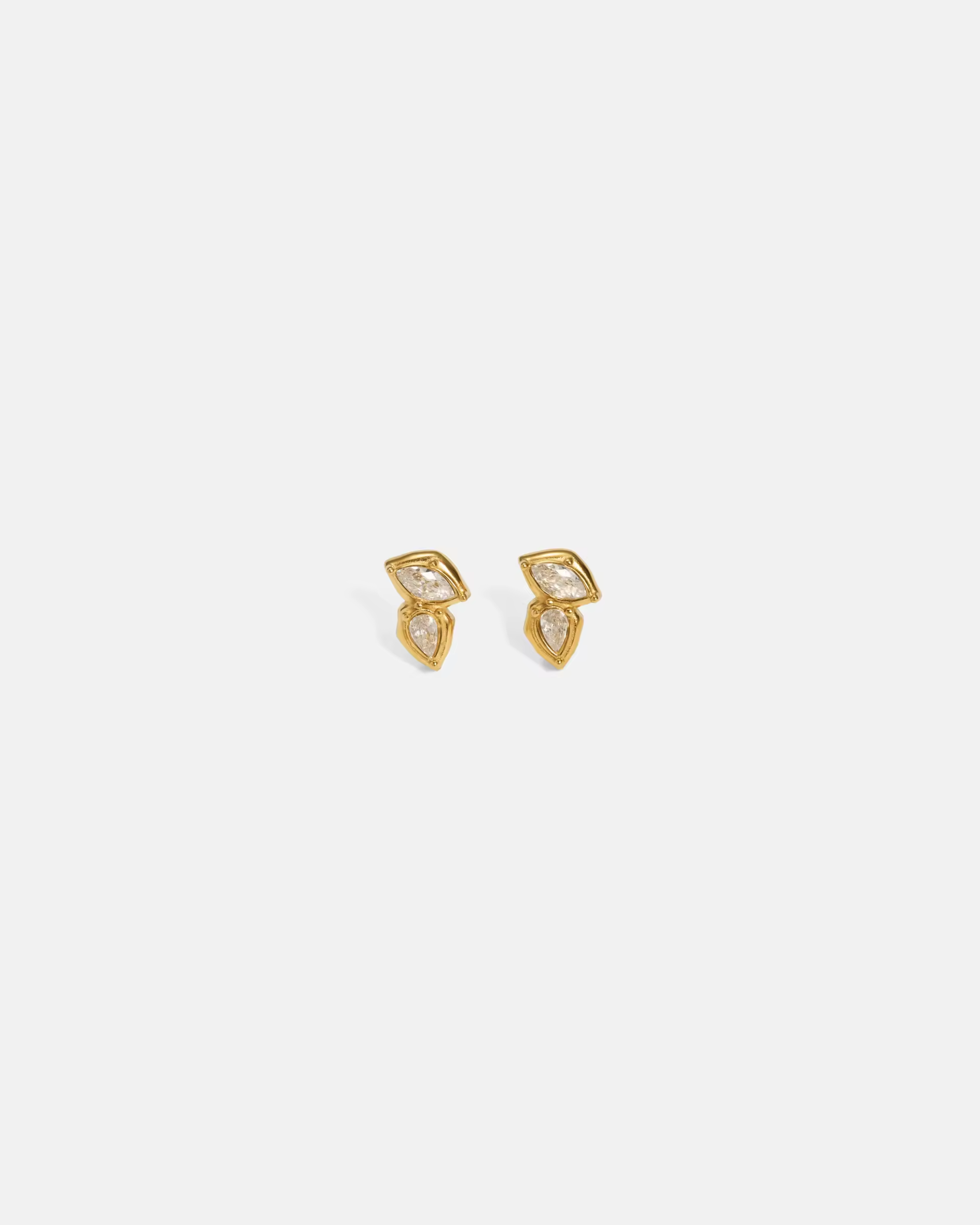 Diamond earring with gold and clear gemstones on a white background