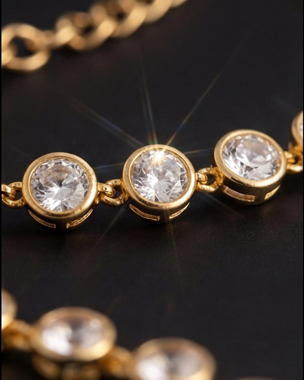 Gold necklace with clear gemstones on a dark background