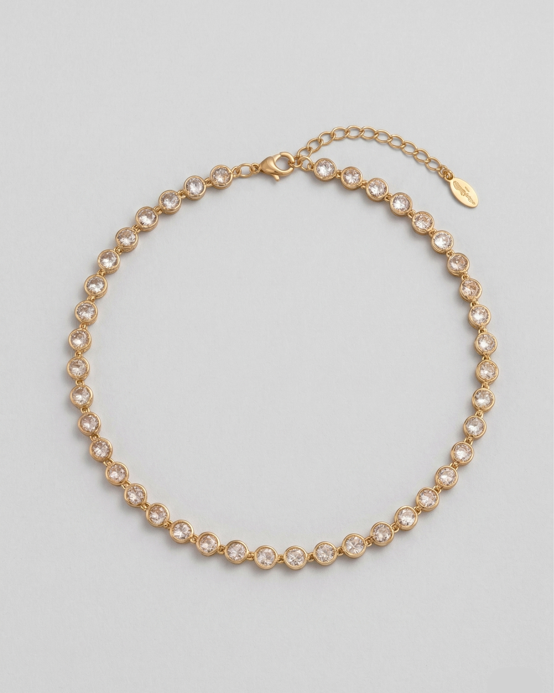 Gold necklace with pearls on a light gray background