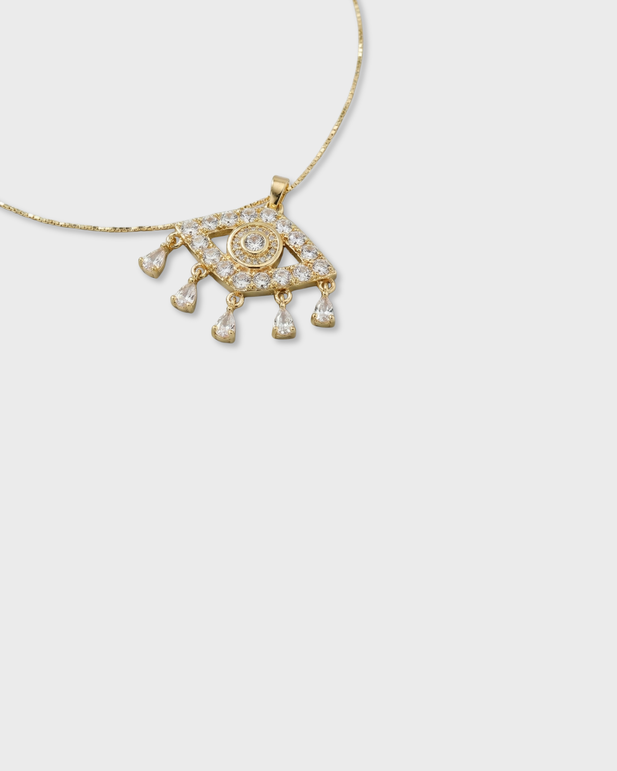 Gold necklace with an eye-shaped pendant on a white background