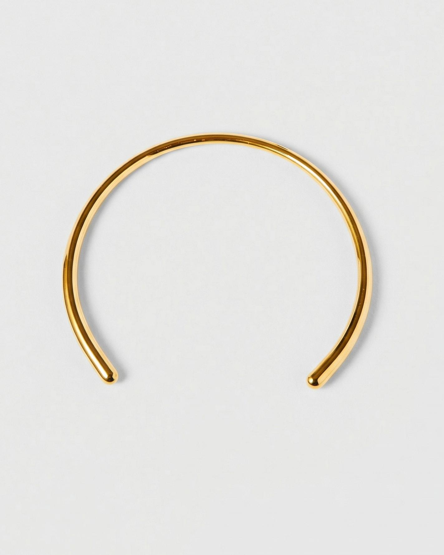Gold headband on a light gray background