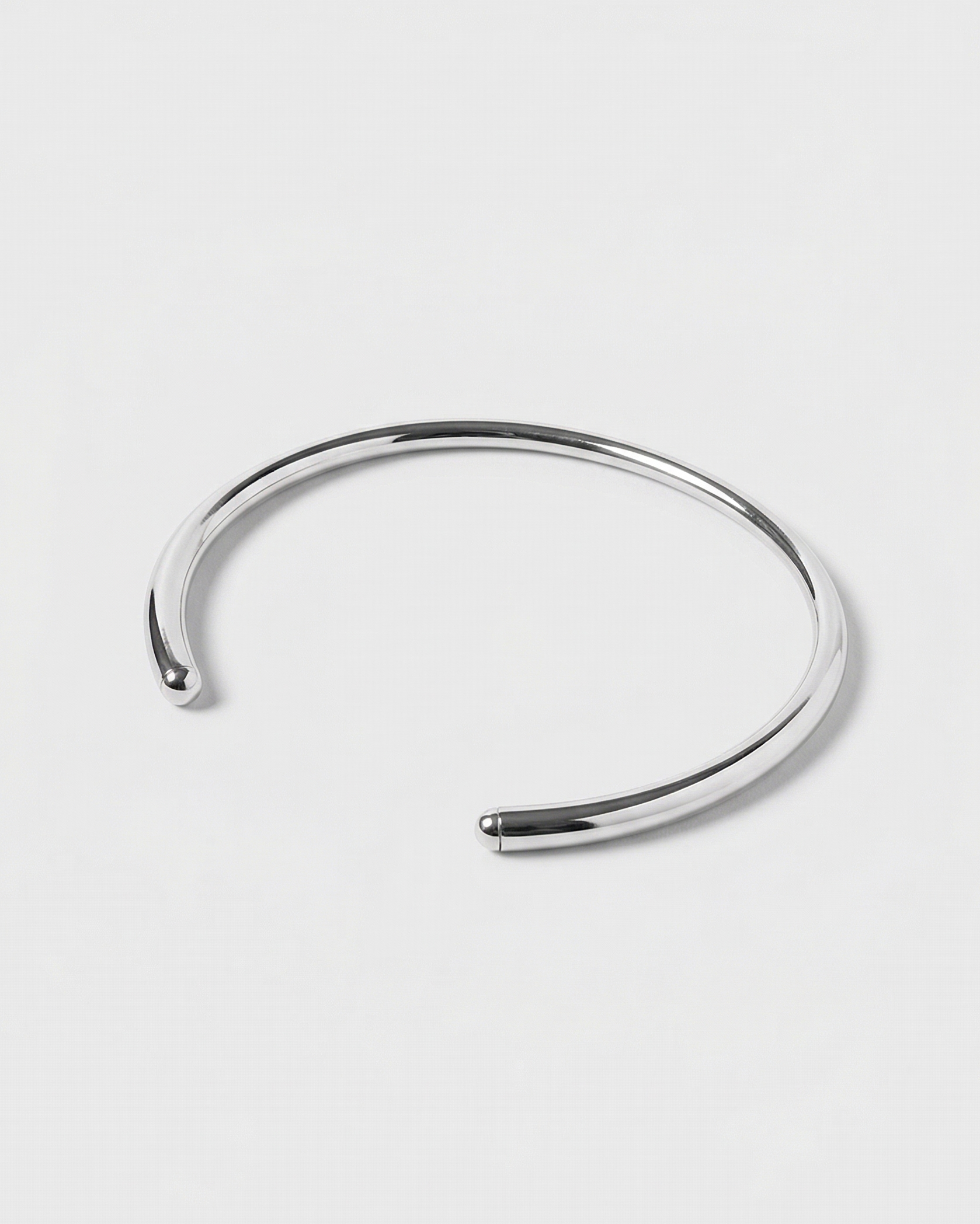 Silver bangle on a light gray background