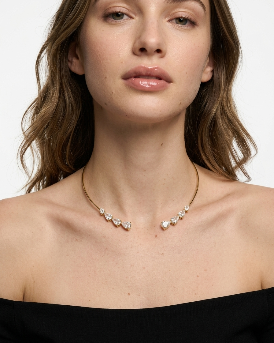 Woman wearing a delicate necklace with a plain background