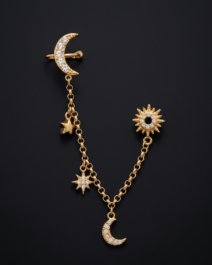 Gold earring with moon, star, and sun charms on a black background
