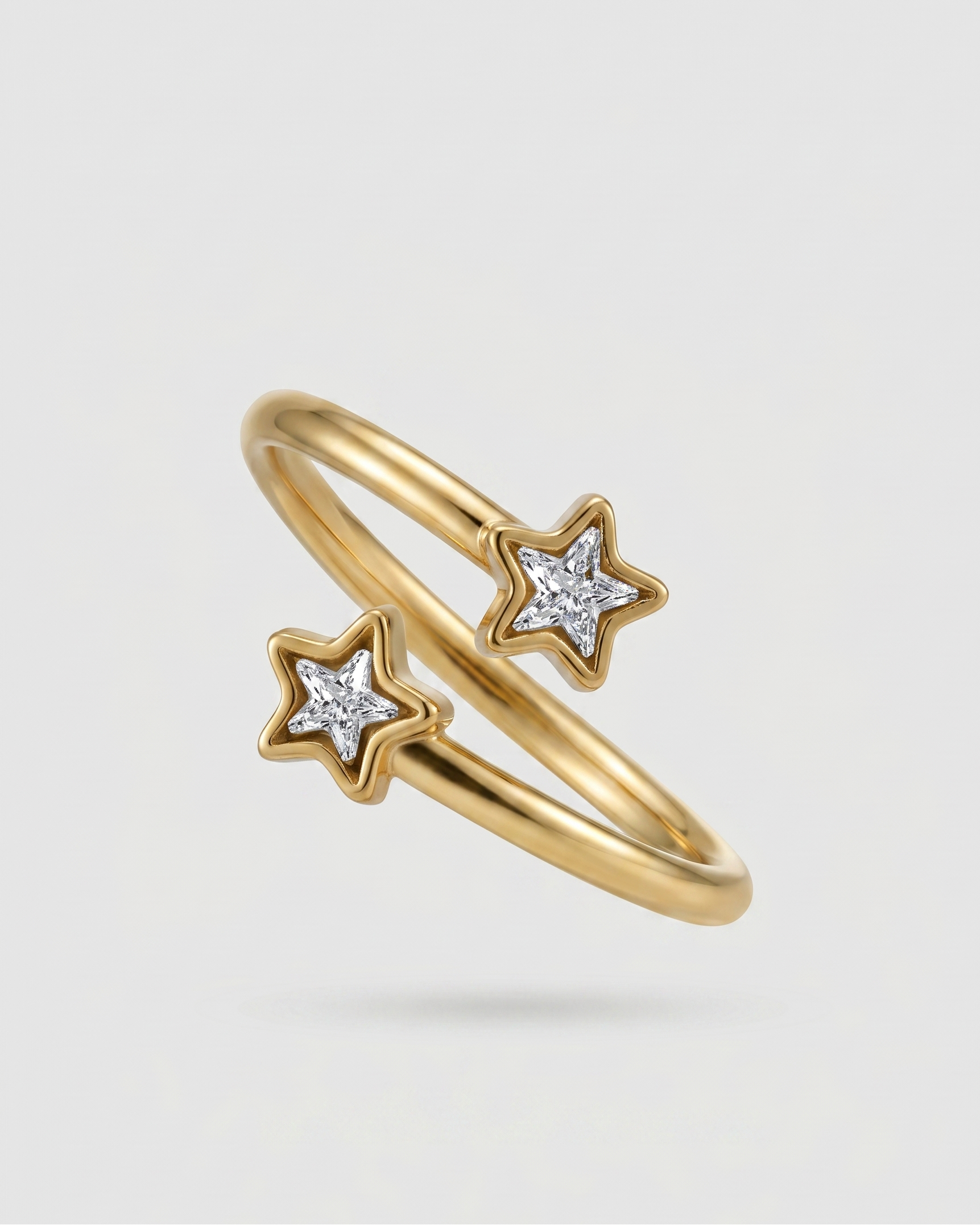 Gold ring with star-shaped diamond cutouts on a light gray background