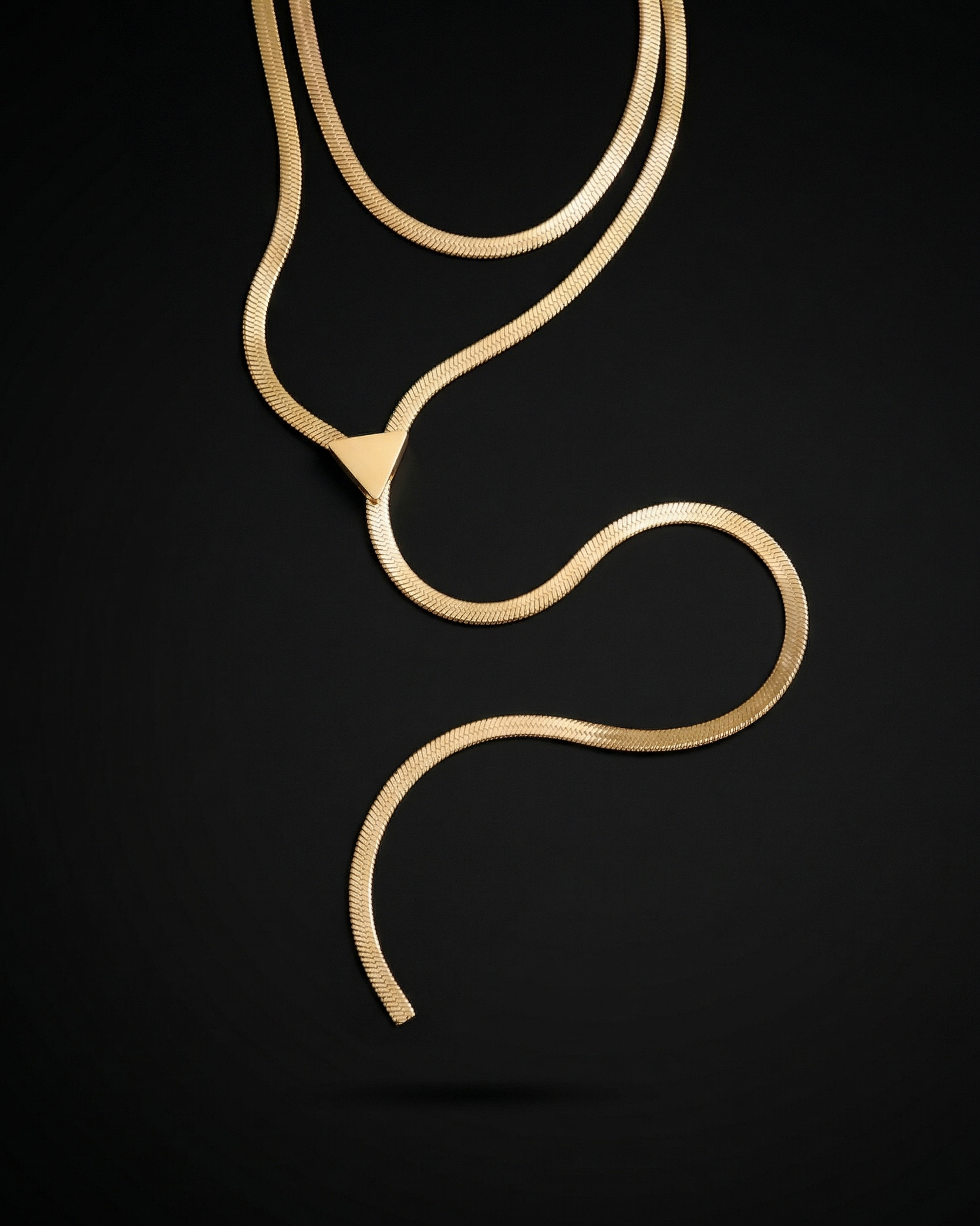 Gold necklace on a black background