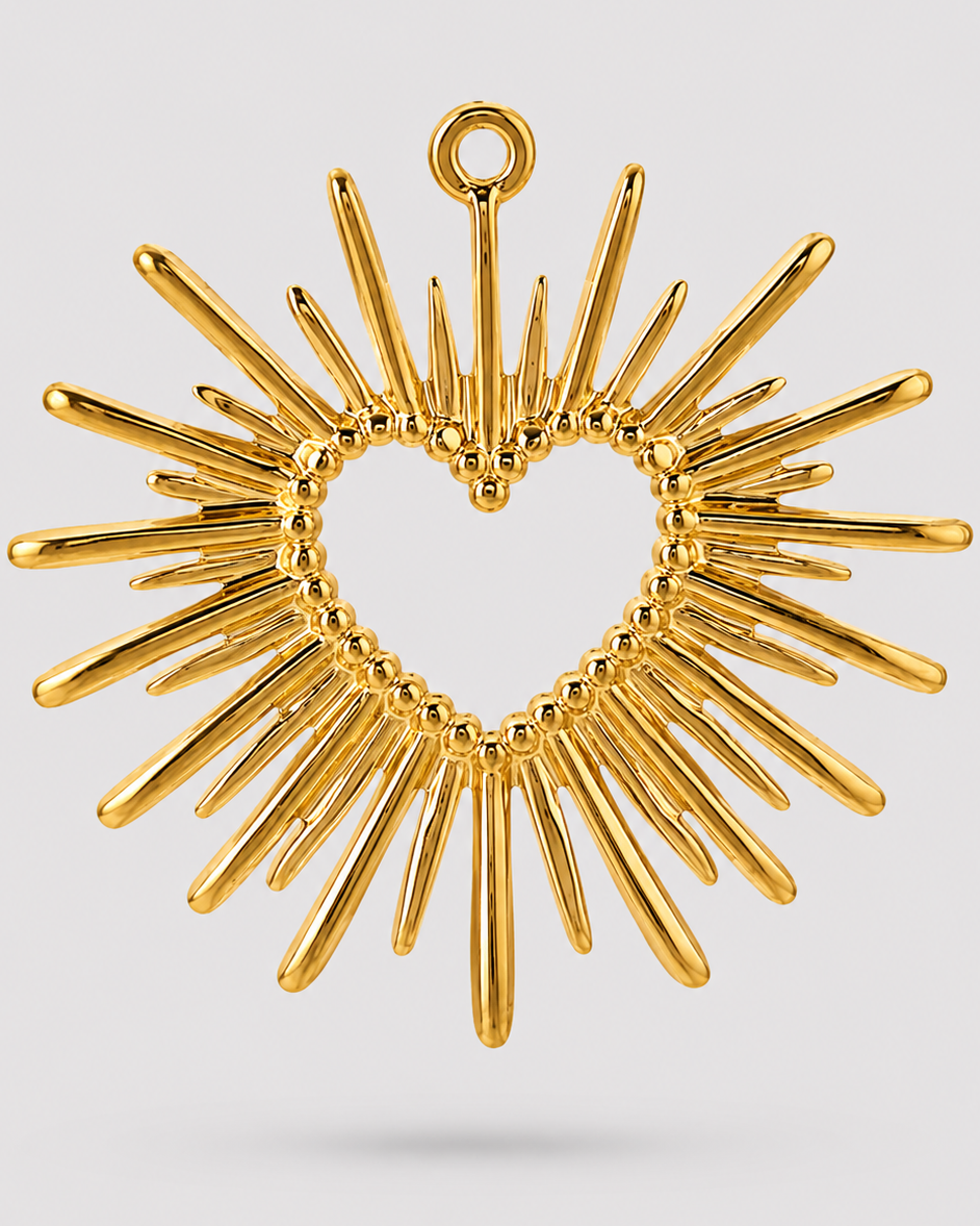 A gold heart-shaped sunburst pendant with radiating spikes and a top loop, shown on a light gray background.