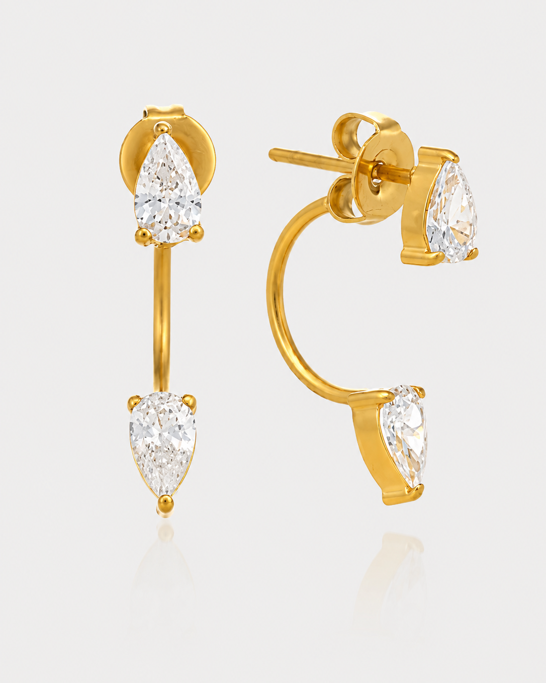 Gold earrings with pear-cut clear gemstones, shown on a light gray background with one earring facing forward and the other angled to show the side profile and post.