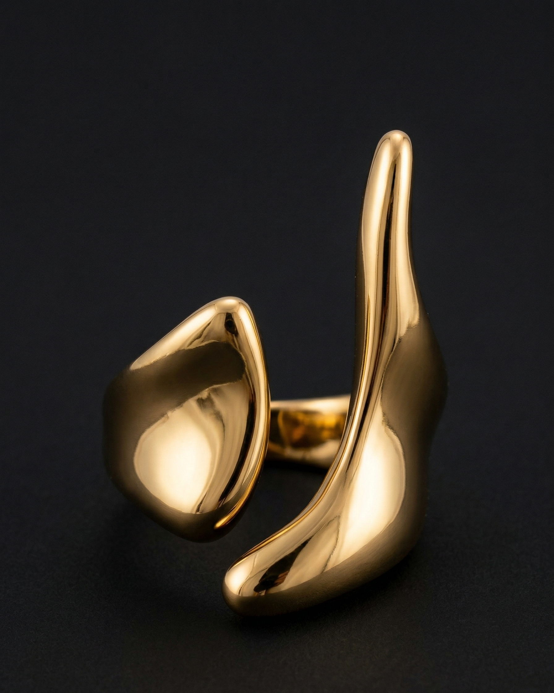 Gold ear cuff on a black background