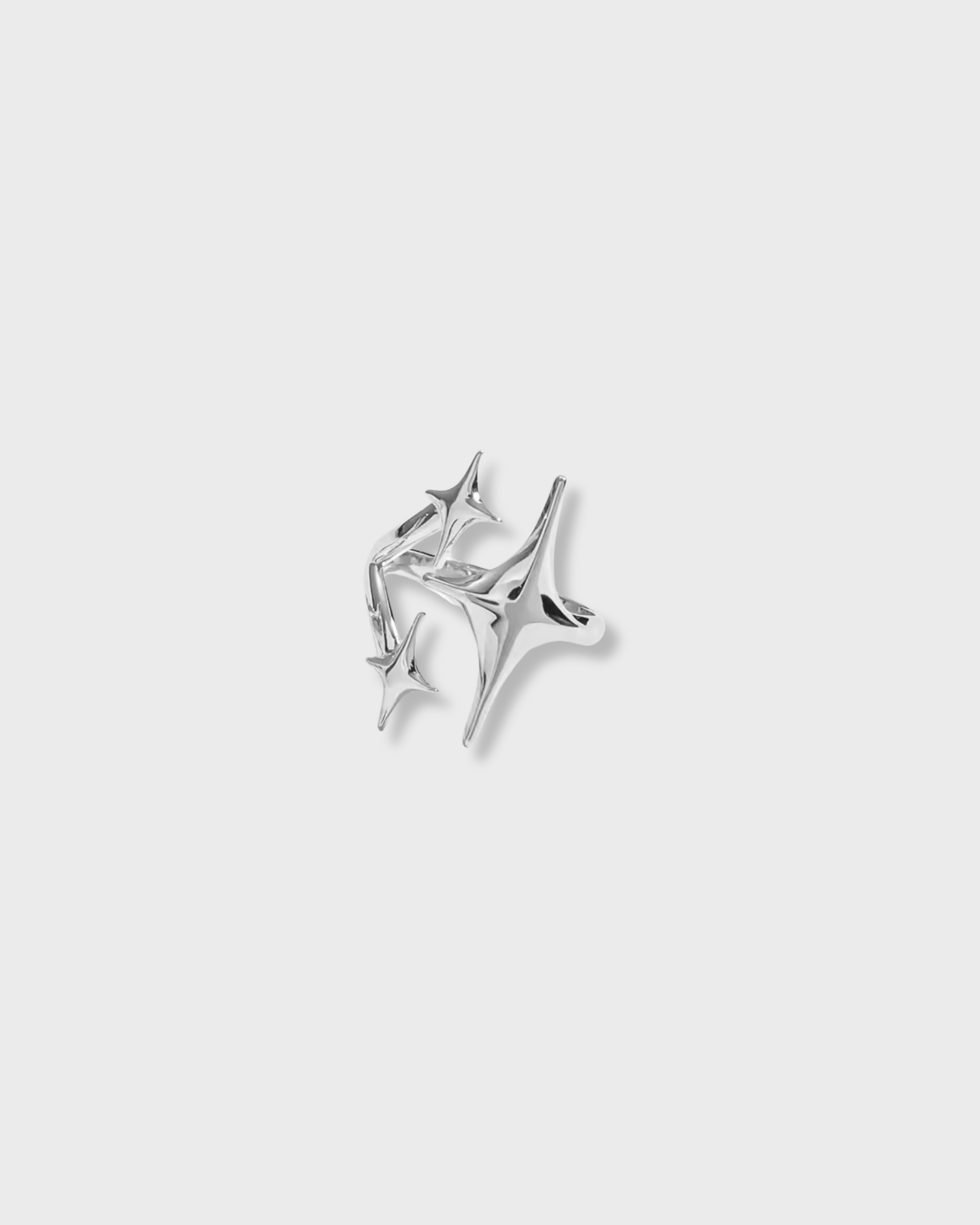 Silver earring on a light gray background
