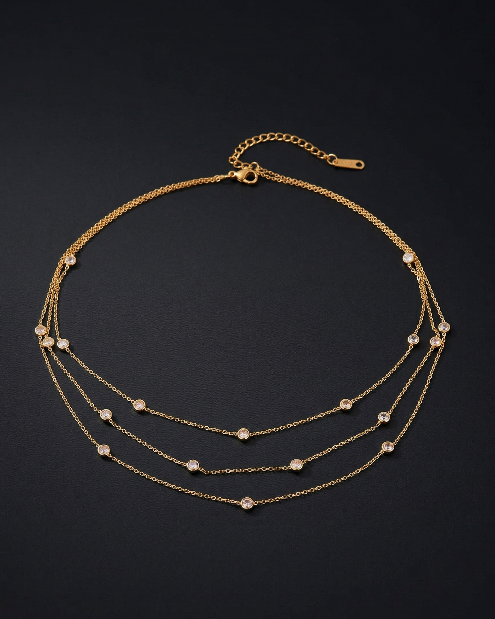 Gold necklace with small beads on a dark background