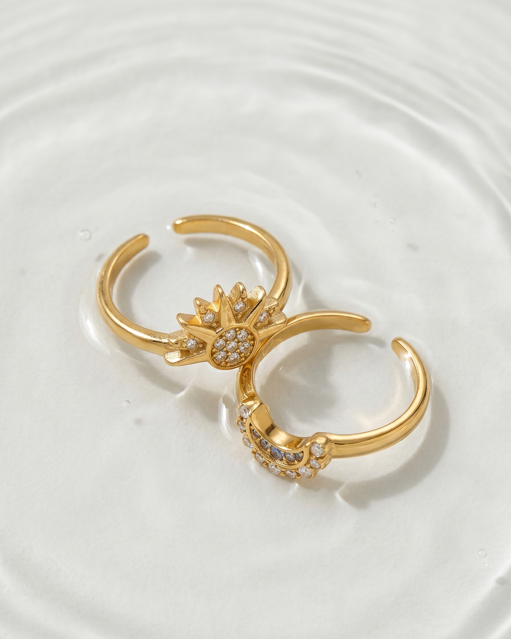 Gold open-toe ring with decorative elements on a white plate
