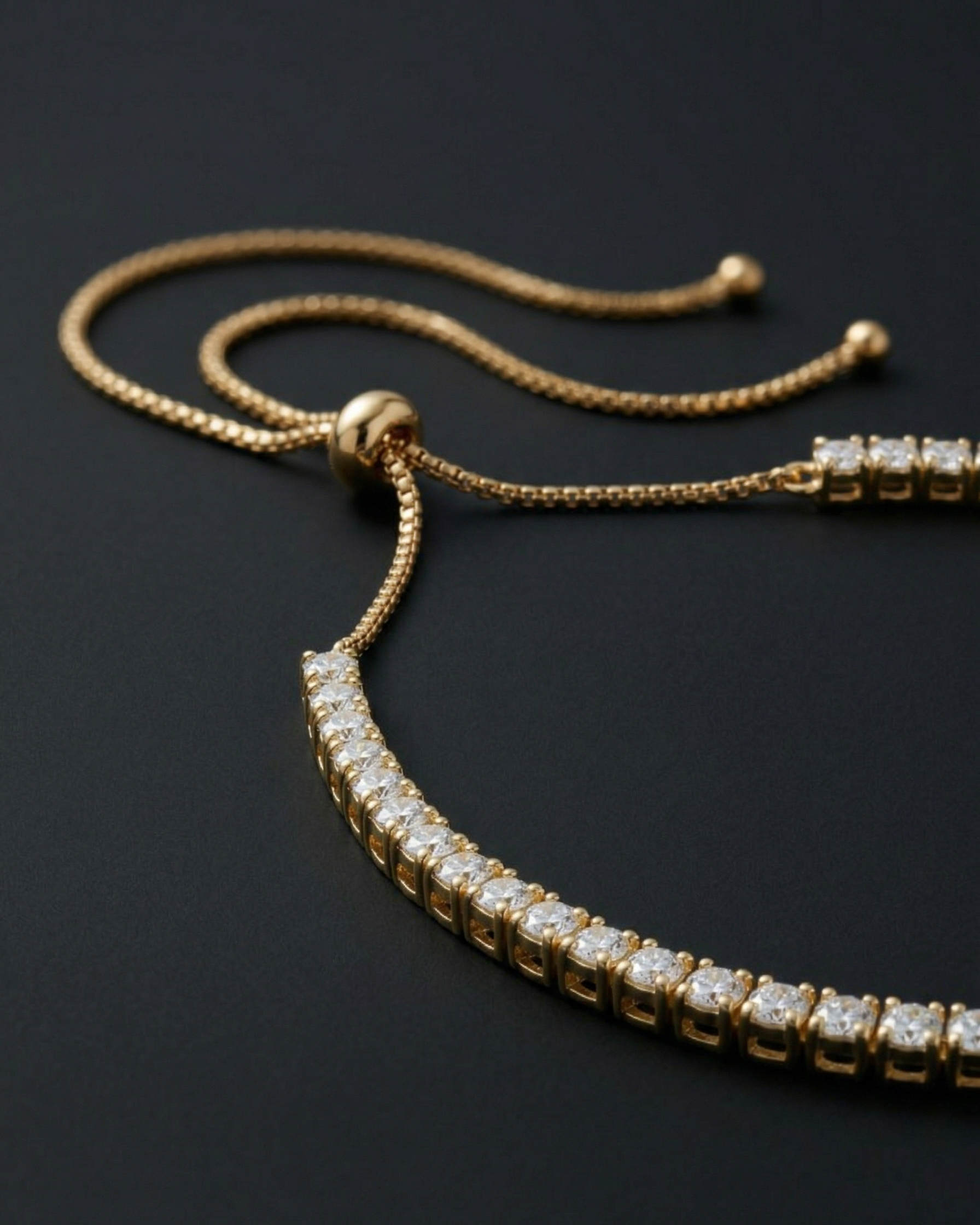 Gold necklace with diamond accents on a black background