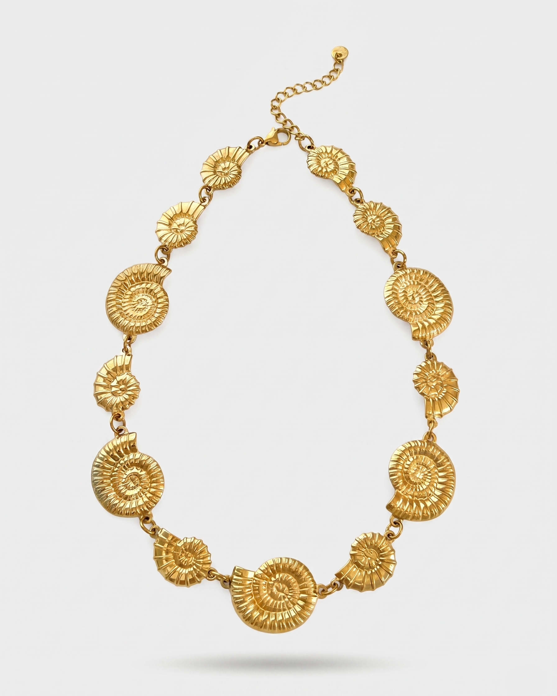 Gold necklace with intricate designs on a white background