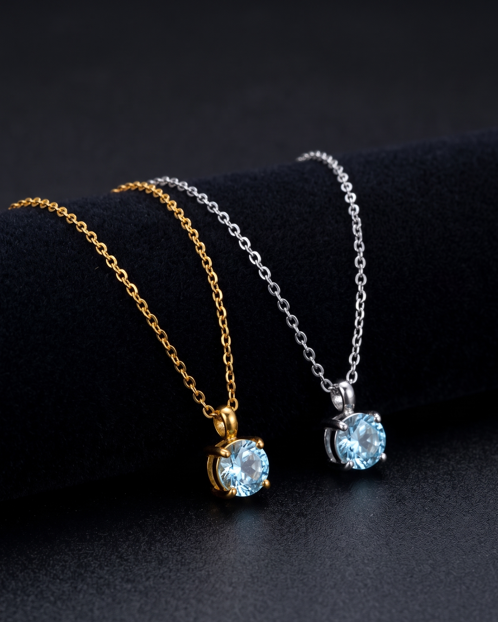 Two necklaces with blue gemstones on a black background