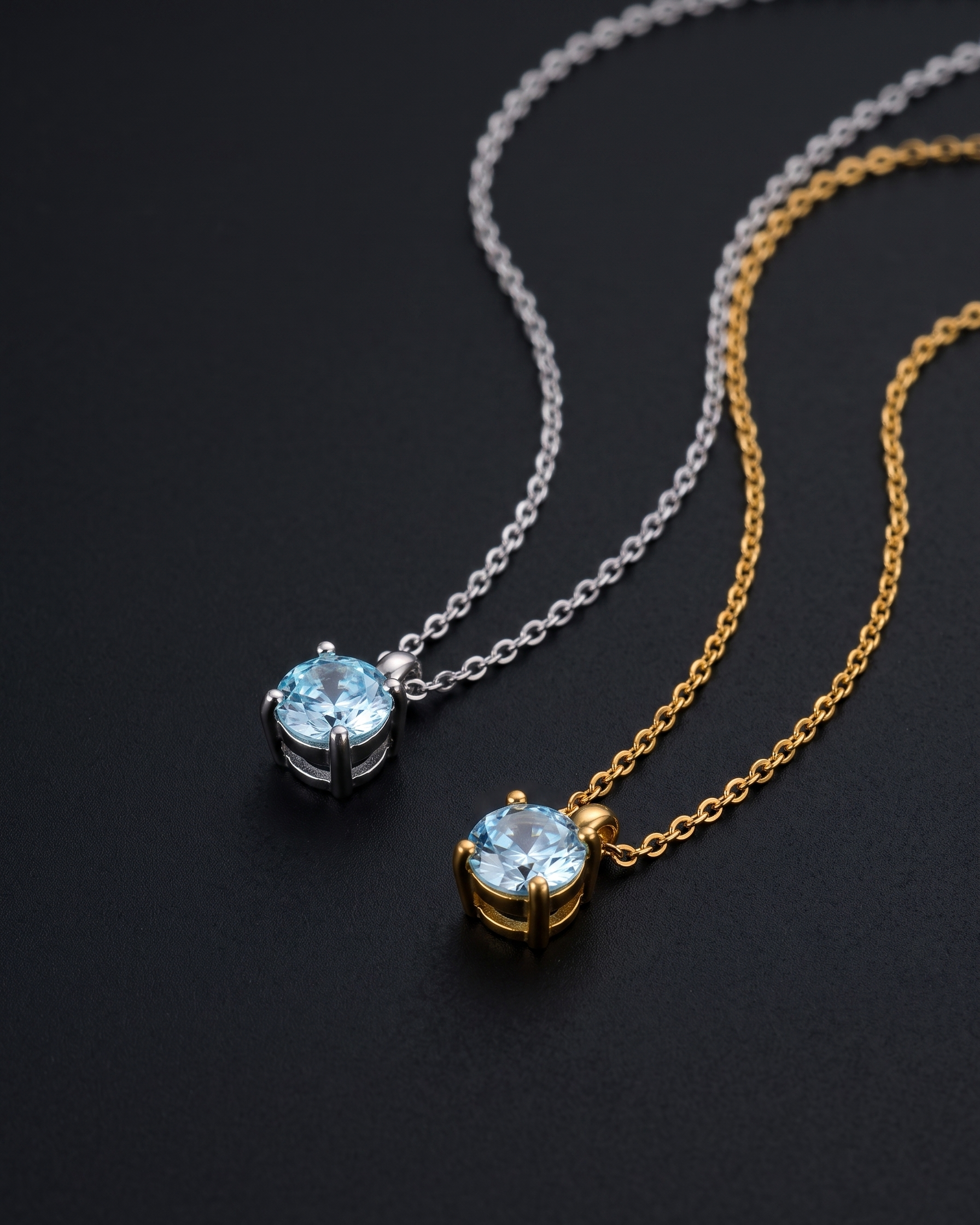 Two necklaces with blue gemstones on black background