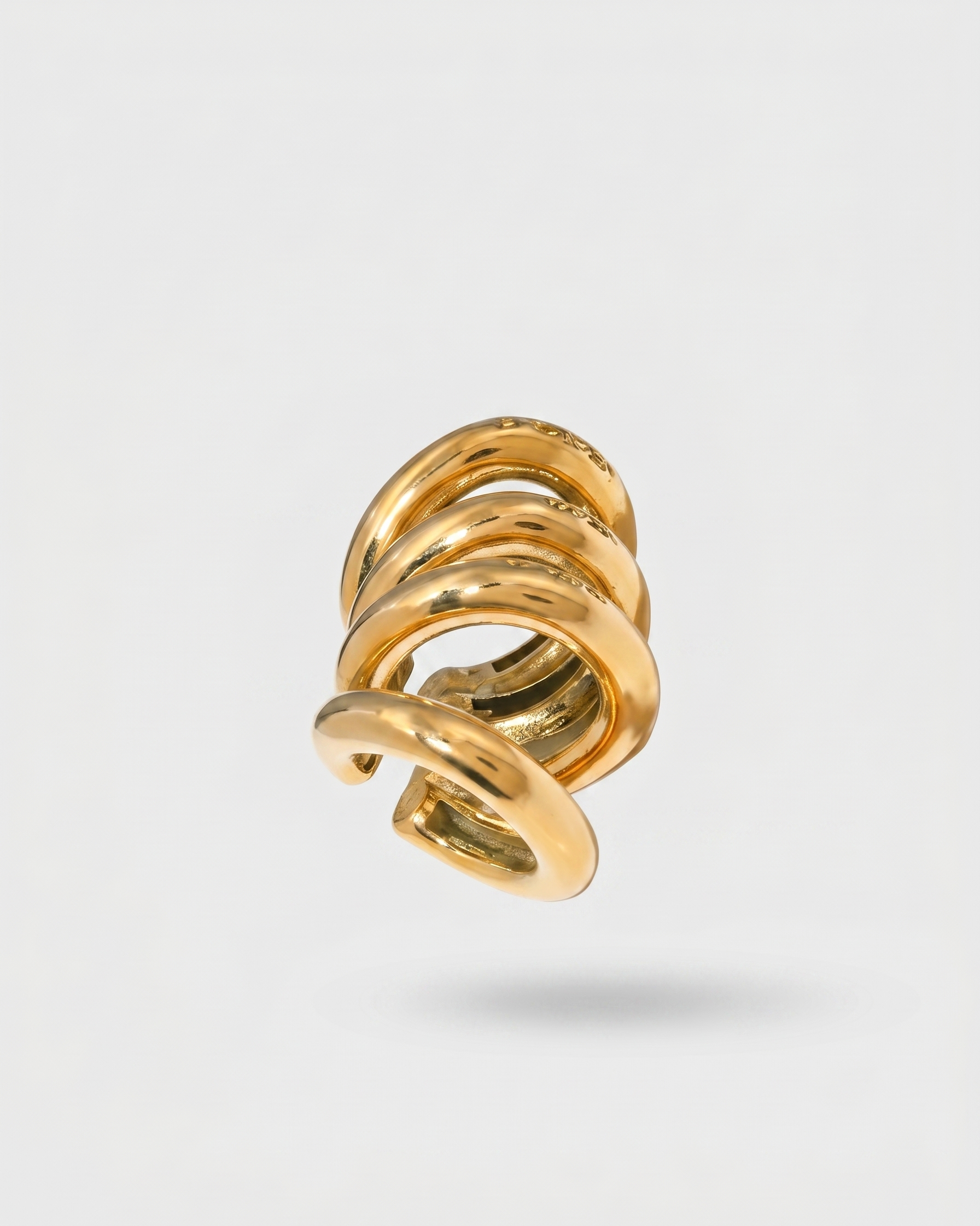 Gold spiral earring on a light gray background