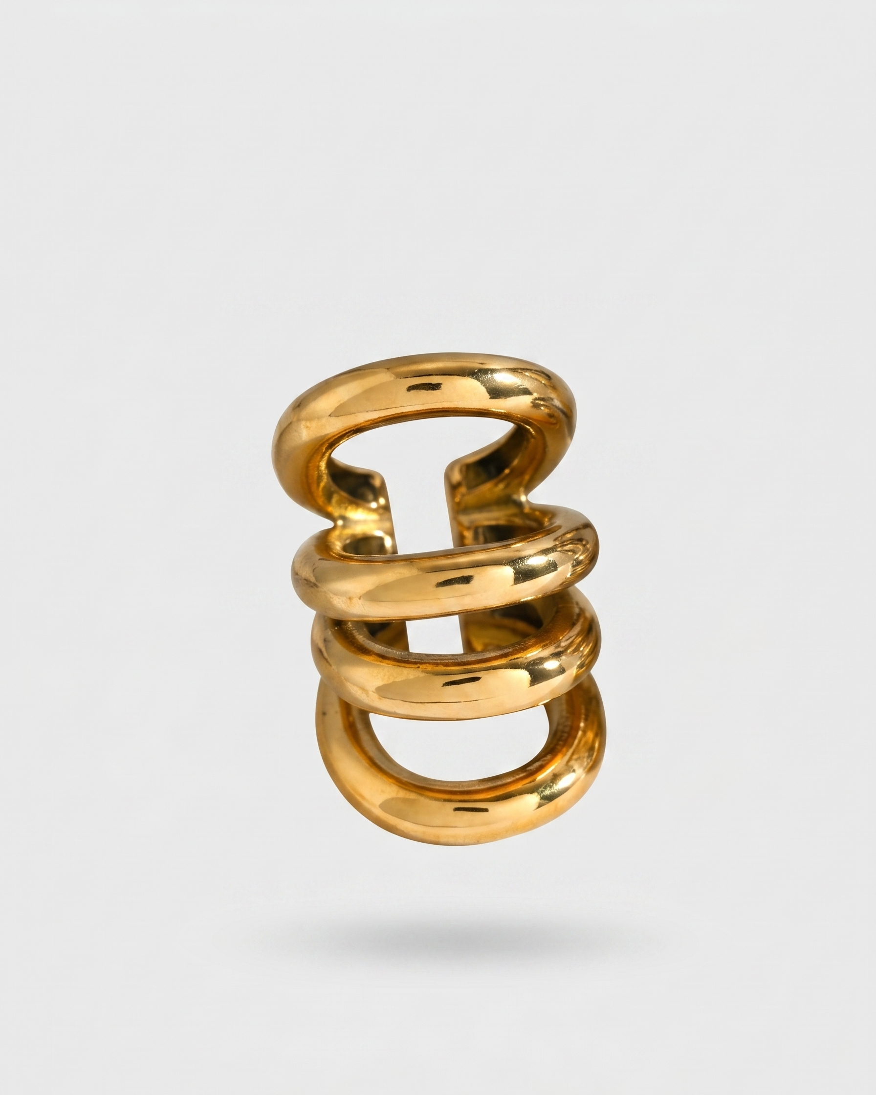 Gold spiral ring on a light gray background