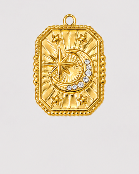 A gold-toned rectangular pendant with a decorative border, featuring a star and crescent moon motif with a small blue accent, shown against a light gray background.