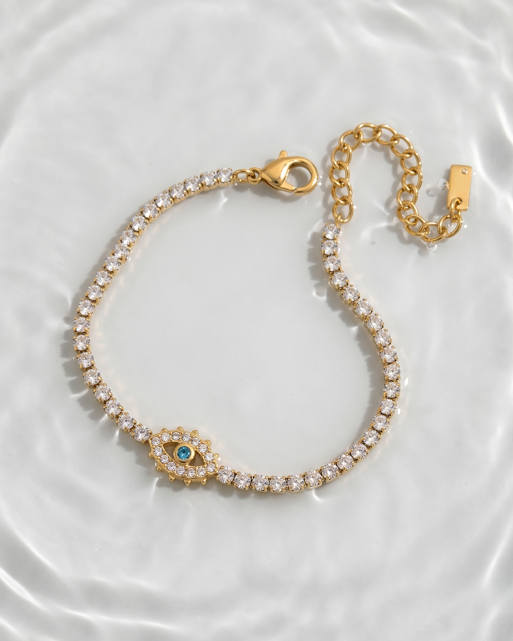 Gold bracelet with a central gemstone on a white background