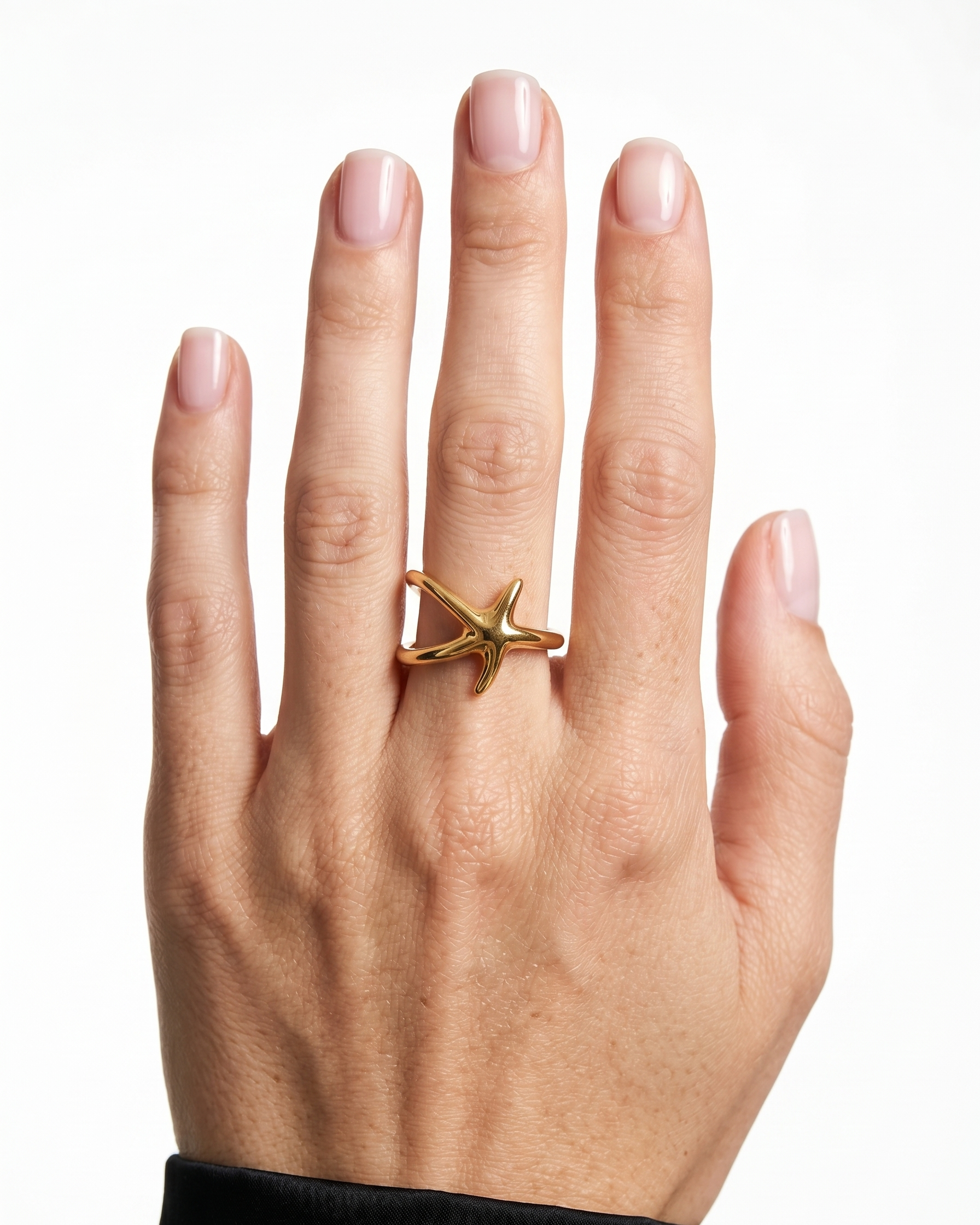 Hand wearing a gold ring on a white background
