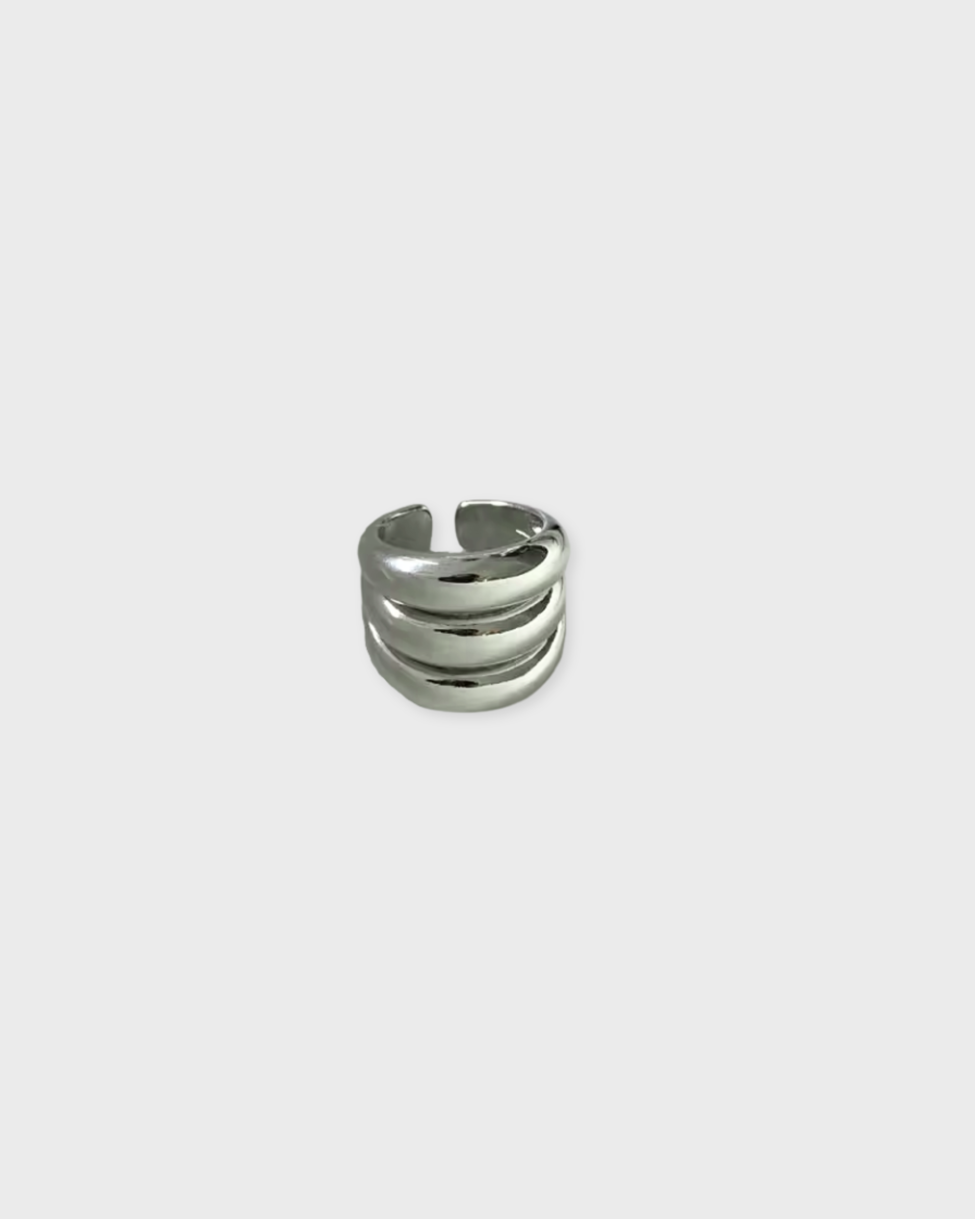 Silver ring on a light gray background