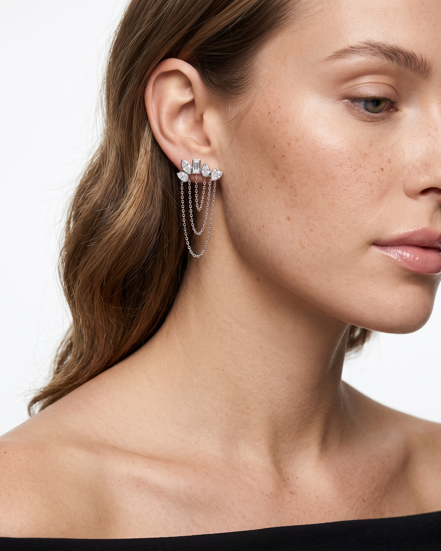 Close-up of a woman wearing a delicate earring with a blurred background