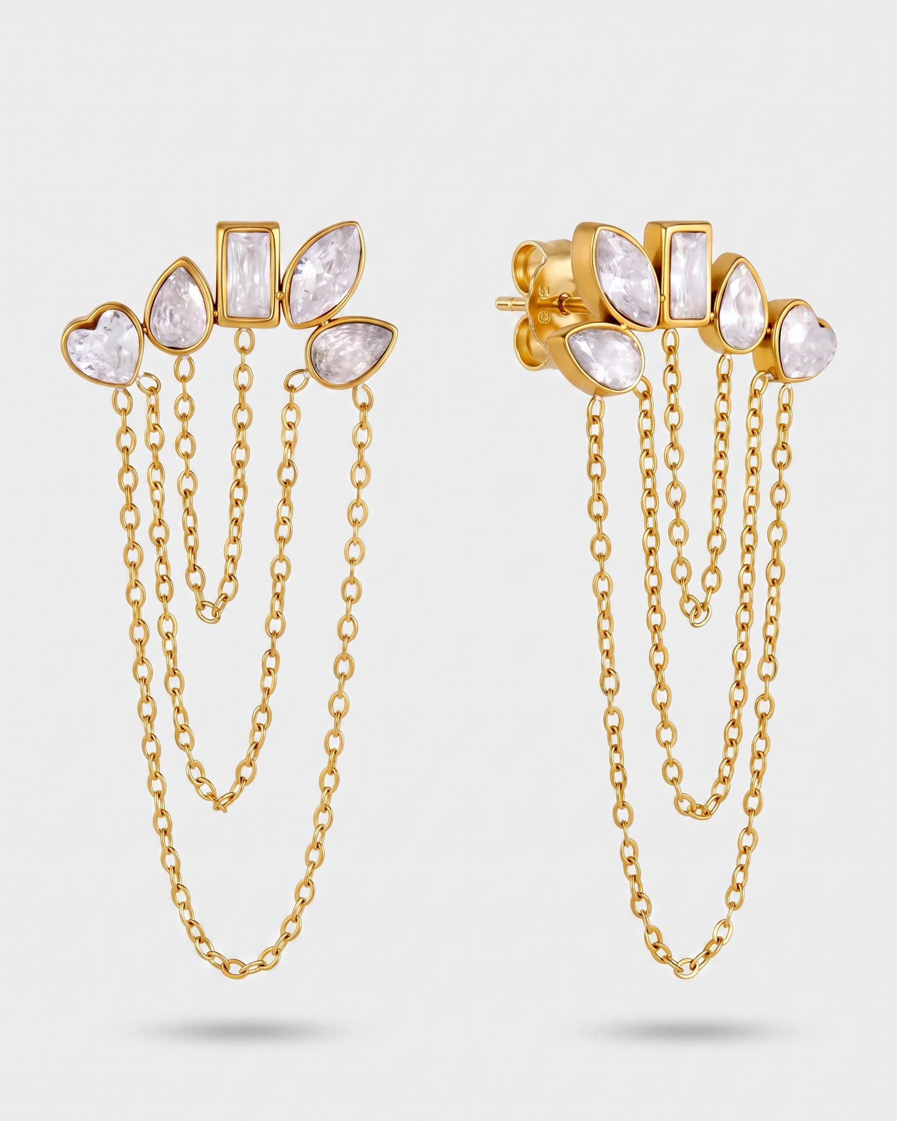 Gold earrings with chain details on a white background