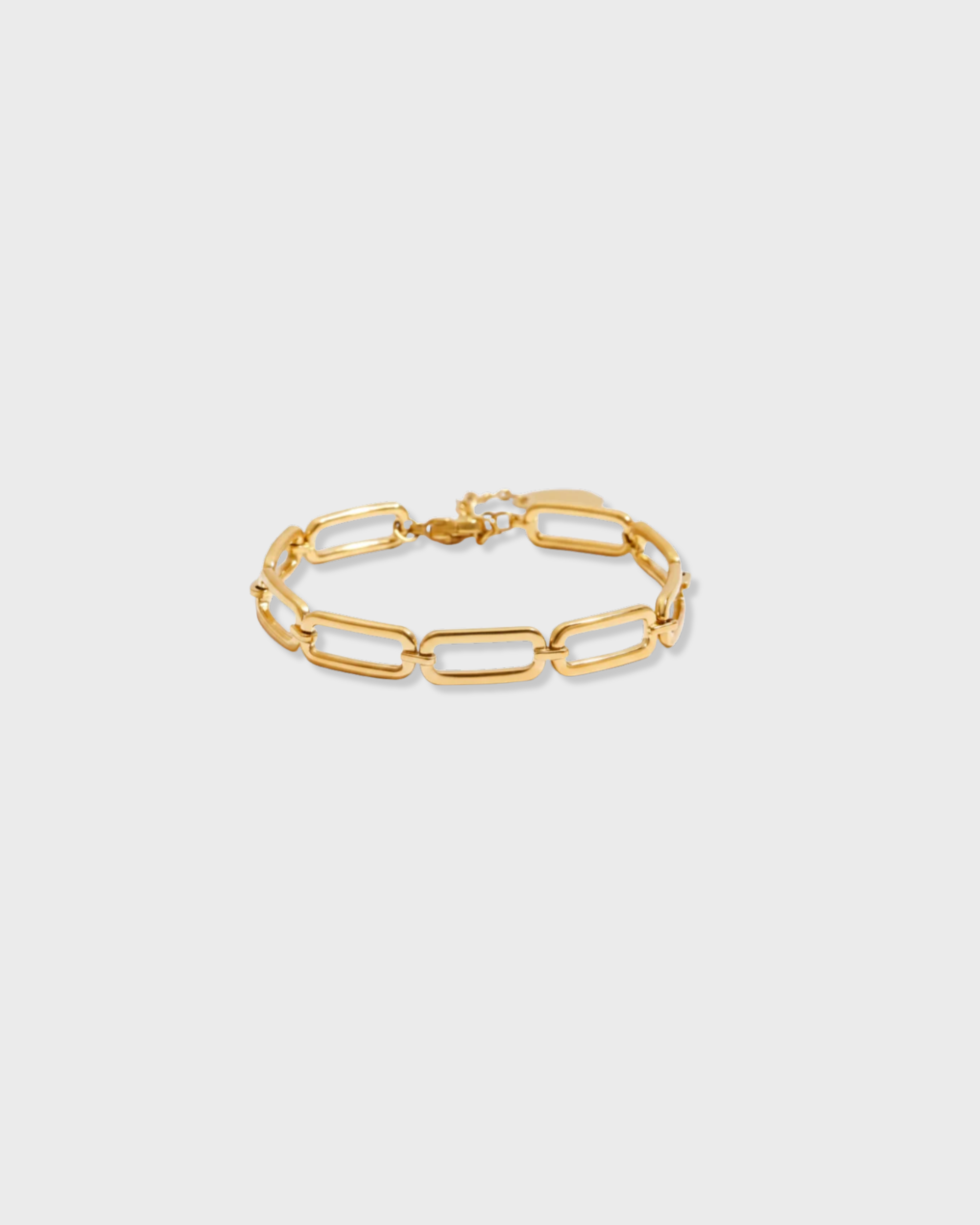 Gold chain bracelet on a light gray background