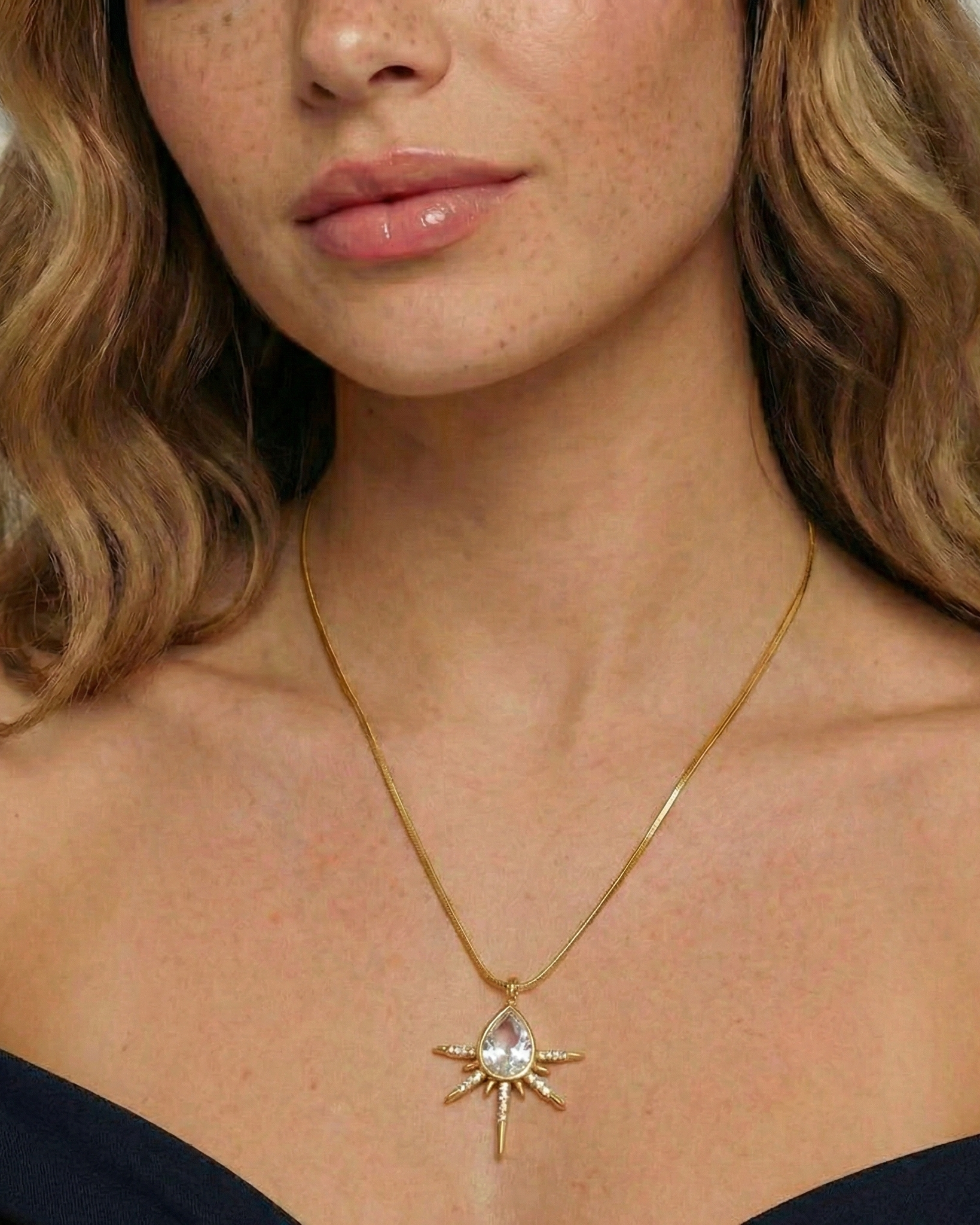 Woman wearing a gold necklace with a star-shaped pendant